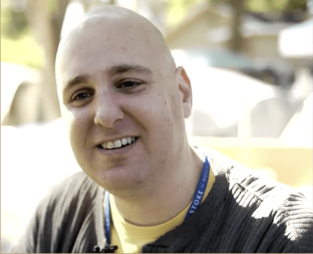 Bald man in black shirt