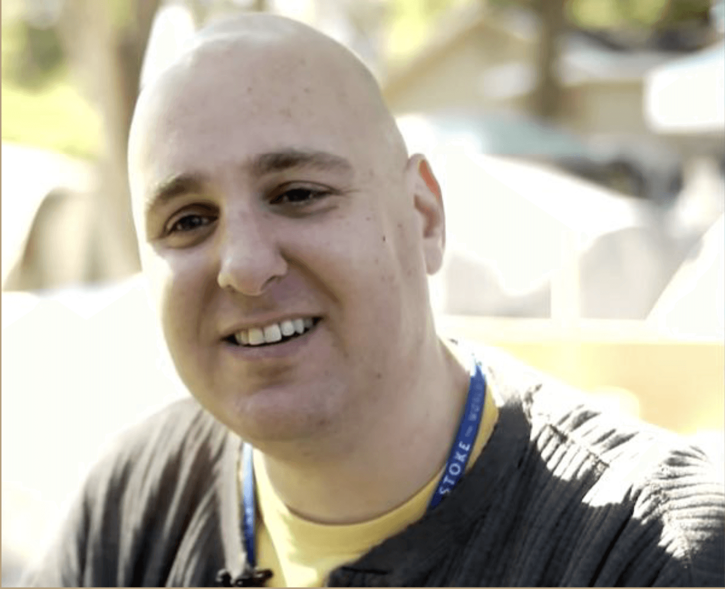 Bald man in black shirt