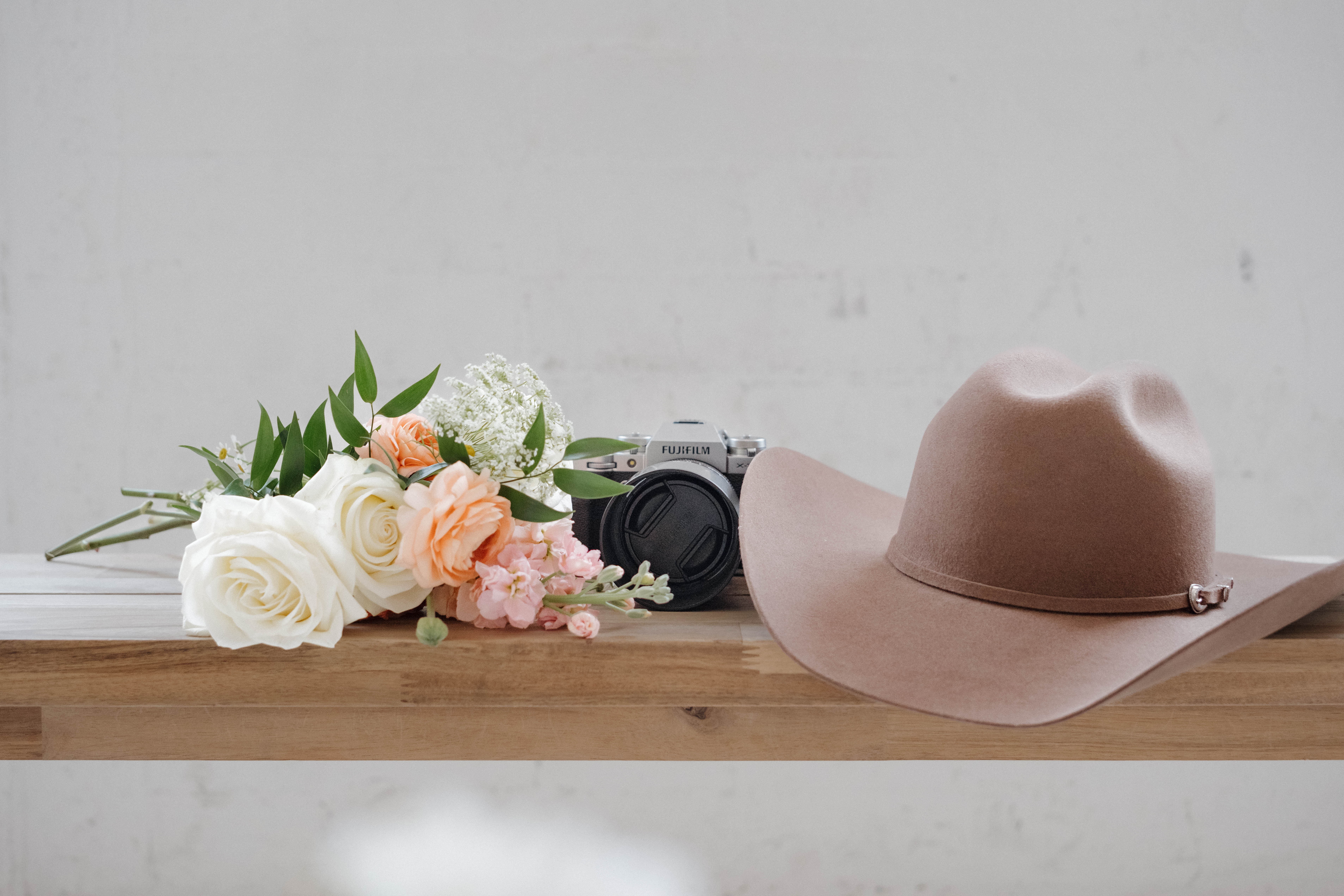 Couple holding ultrasound photos, with the woman kissing the man's cheek, announcing their pregnancy in Chandler, Arizona.