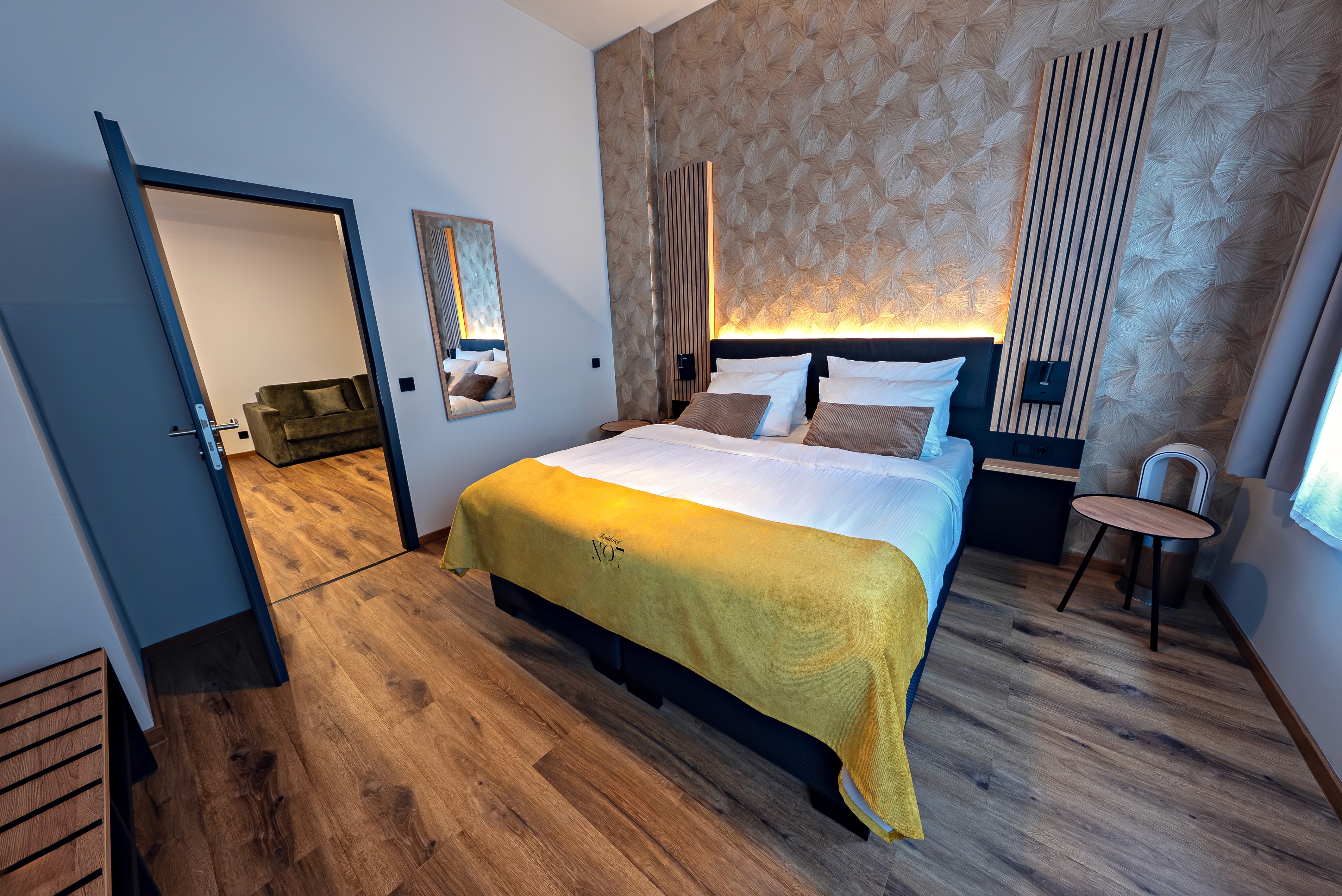 A serene garden-view hotel suite with private patio surrounded by tropical plants