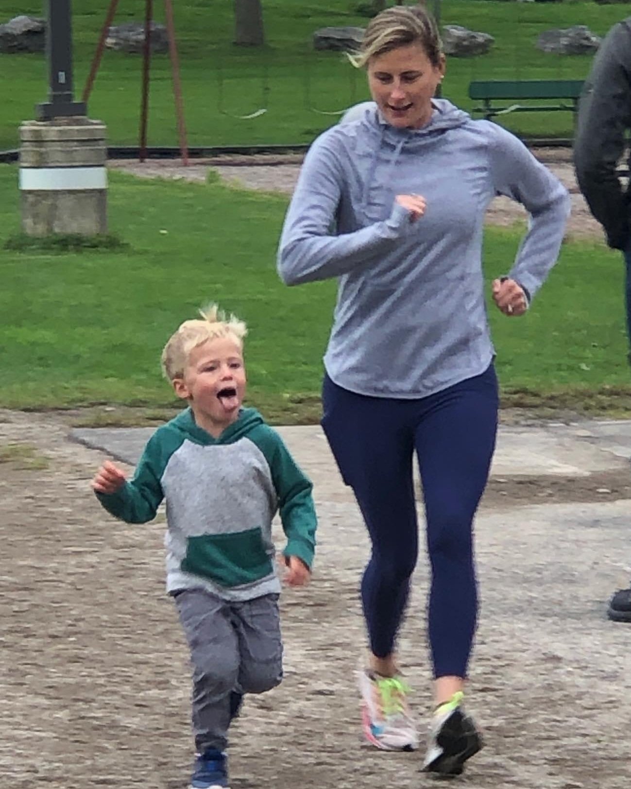 mother and young child jogging along a path in a park