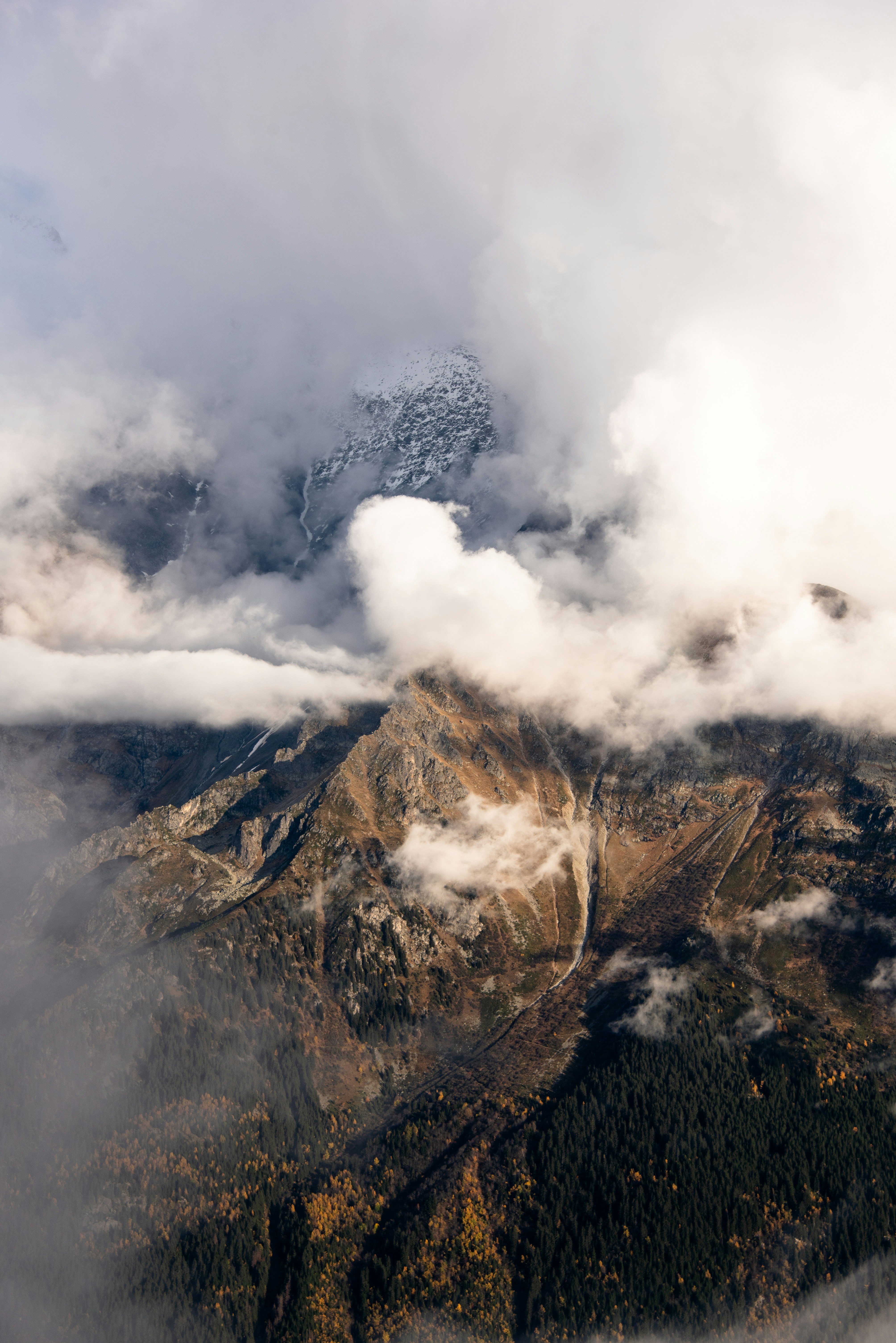 Majestic mountain peak emerges from swirling clouds