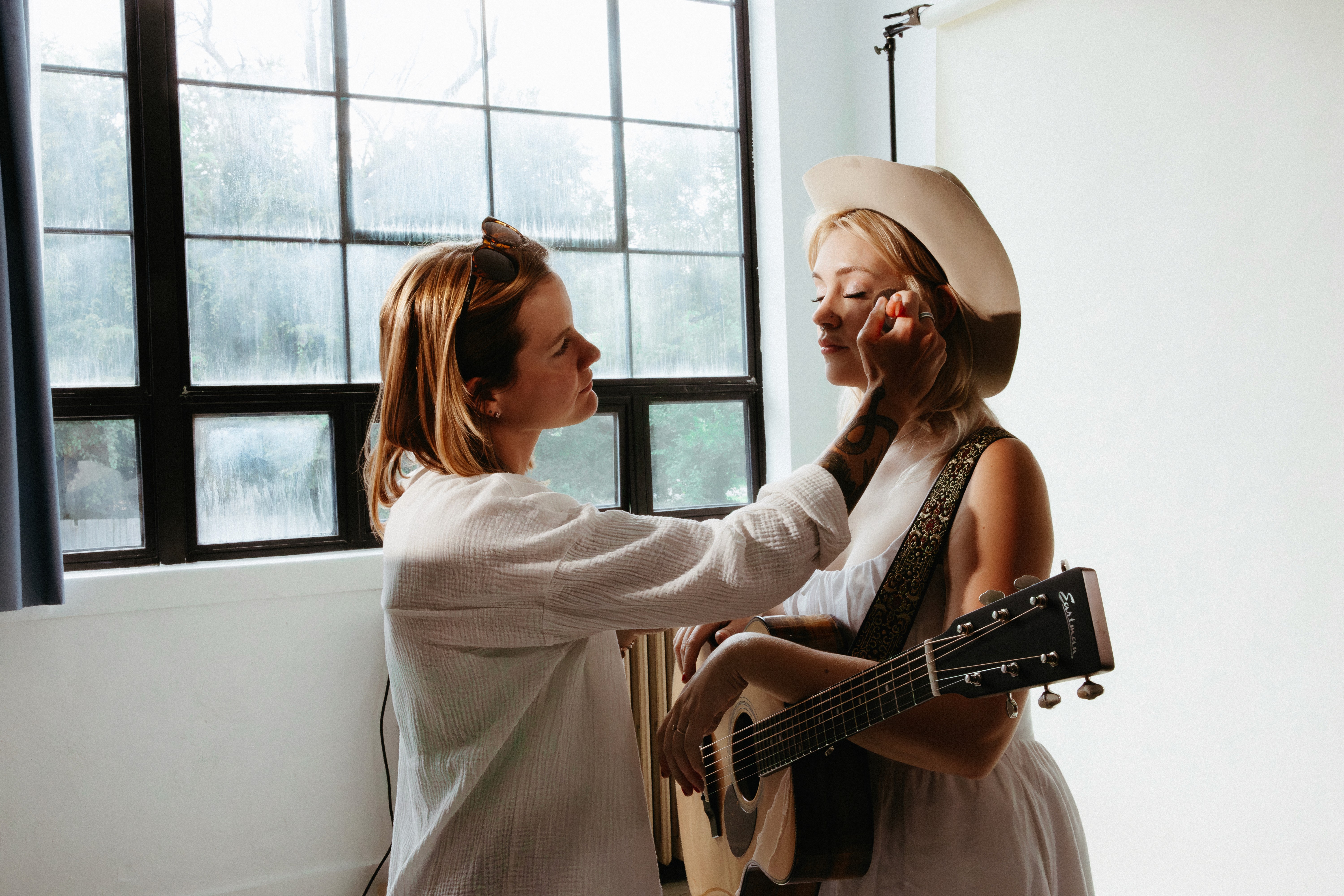 BTS photo of Guinevere's photoshoot as she gets her makeup touched up