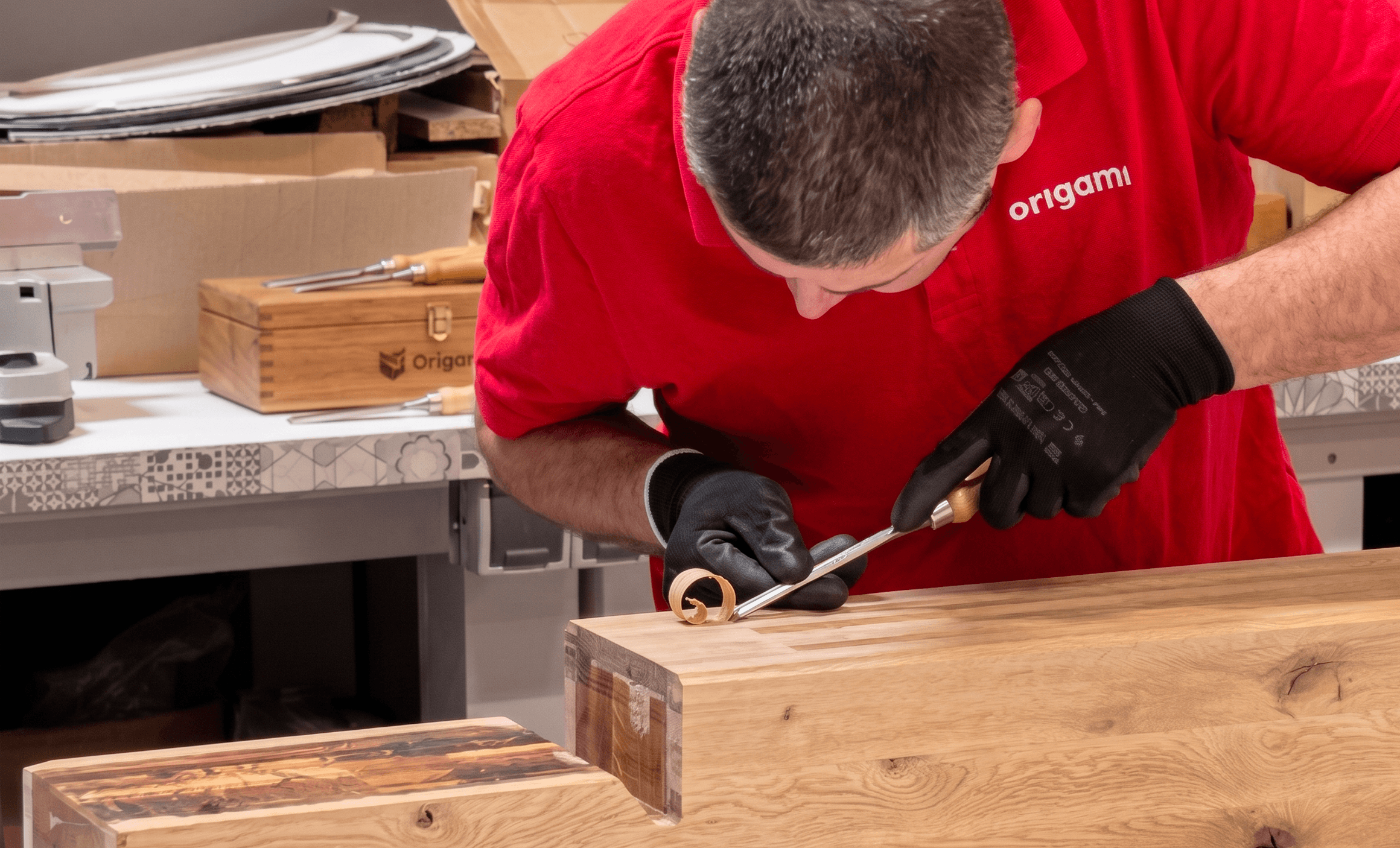 Skilled craftsman working by hand on a piece of wood in a workshop