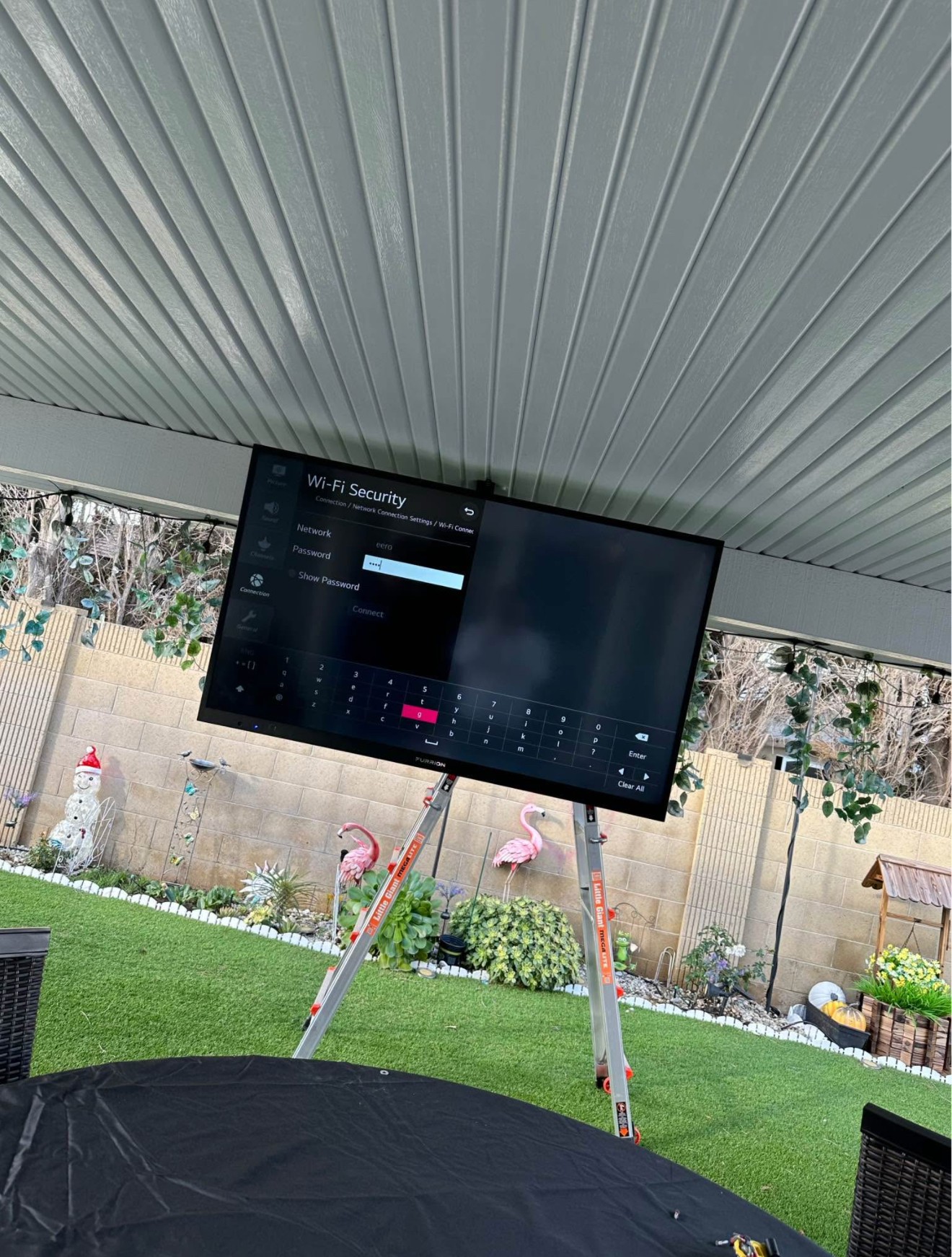 60-inch TV mounted using a ceiling mount setup in a residential home in Miami, with clean wiring and a modern look.