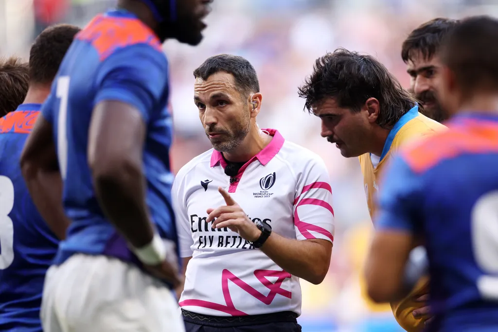photo of rugby referee amongst the players