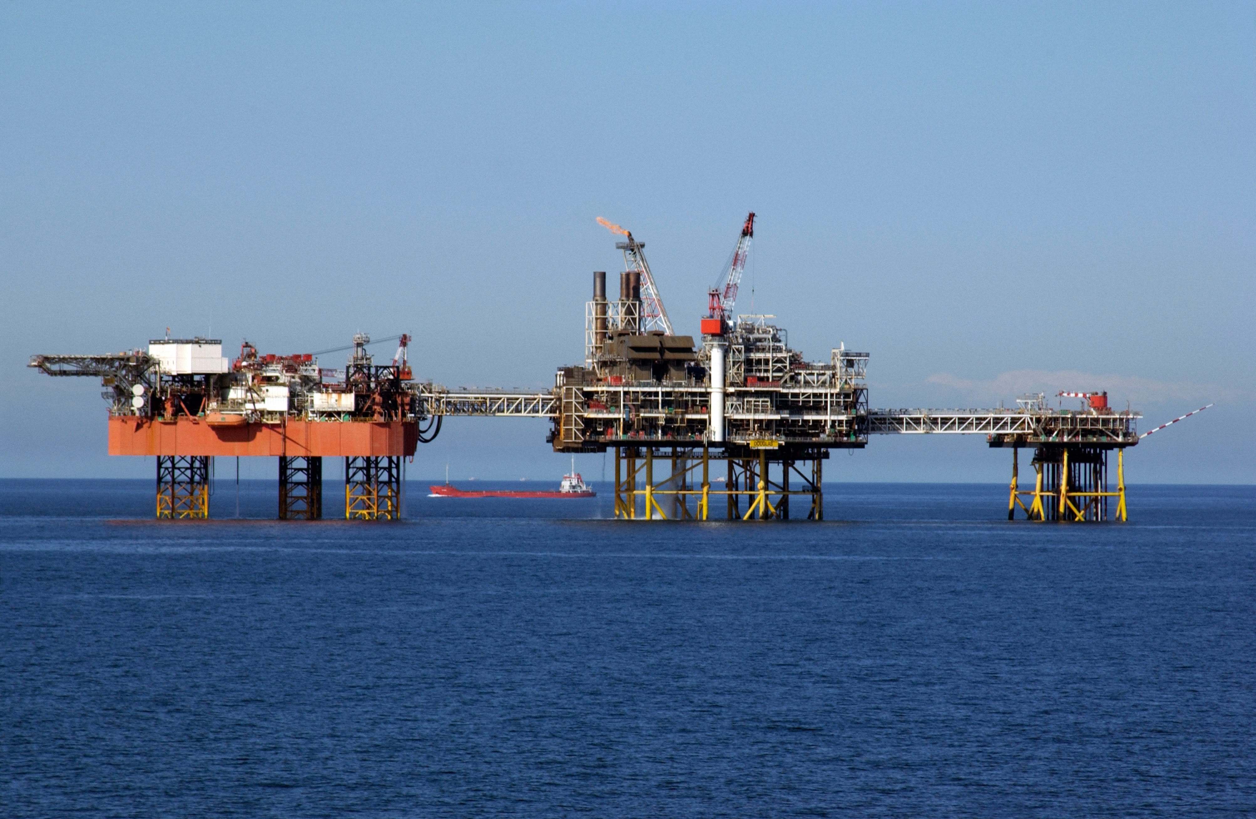red and black metal tower during sunset