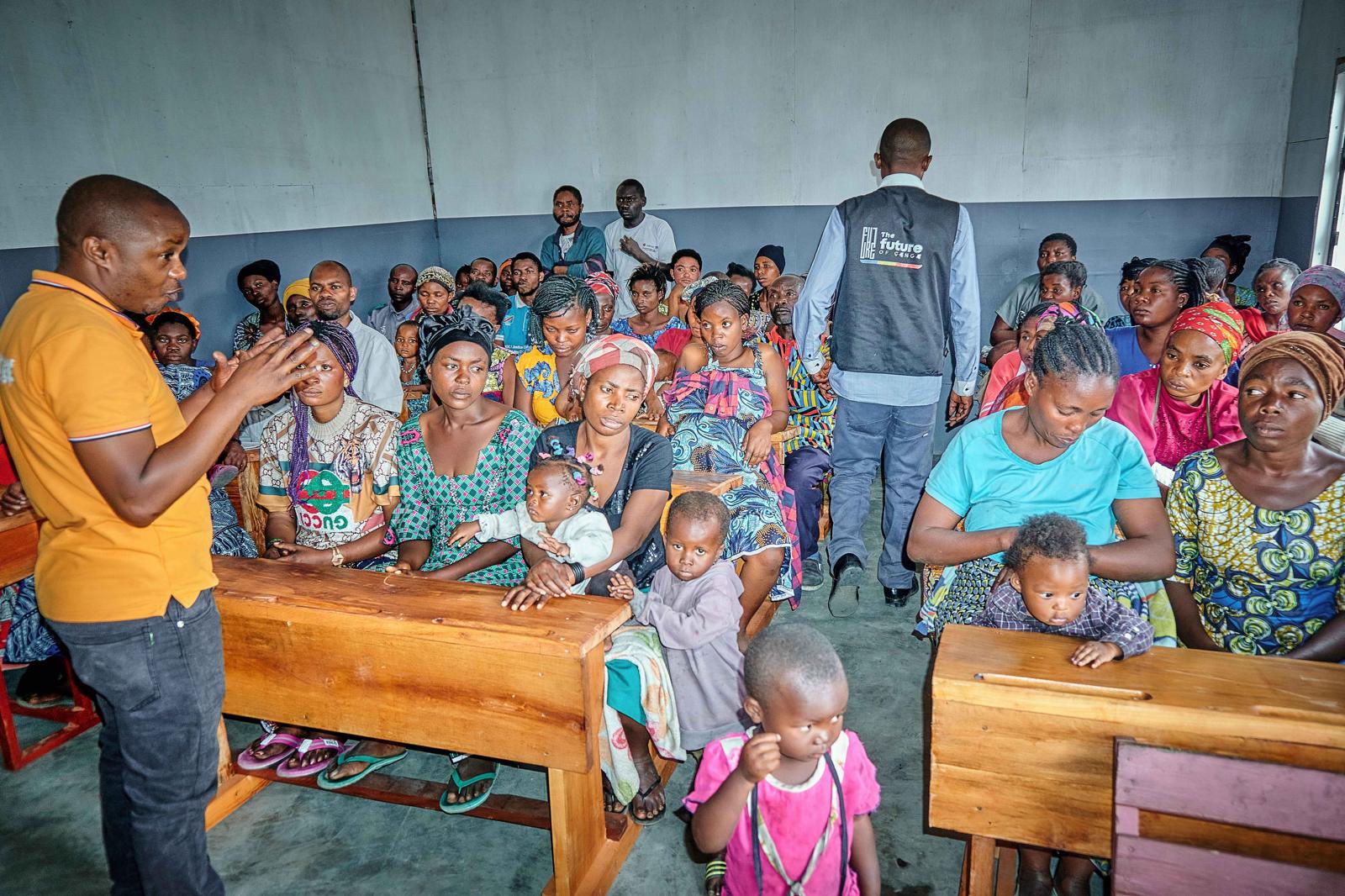 selective focus photography of woman standing surrounded by plants
