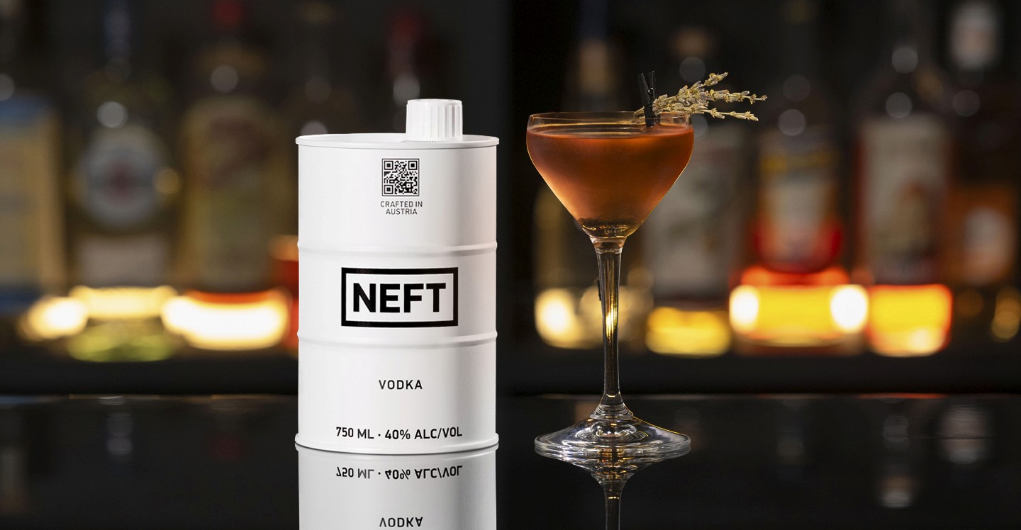 A NEFT Barrel and a glass of Holiday Wish on a bar counter.
