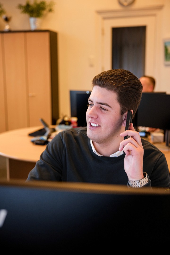 man in green and black plaid long sleeve shirt holding red and black cordless hand drill