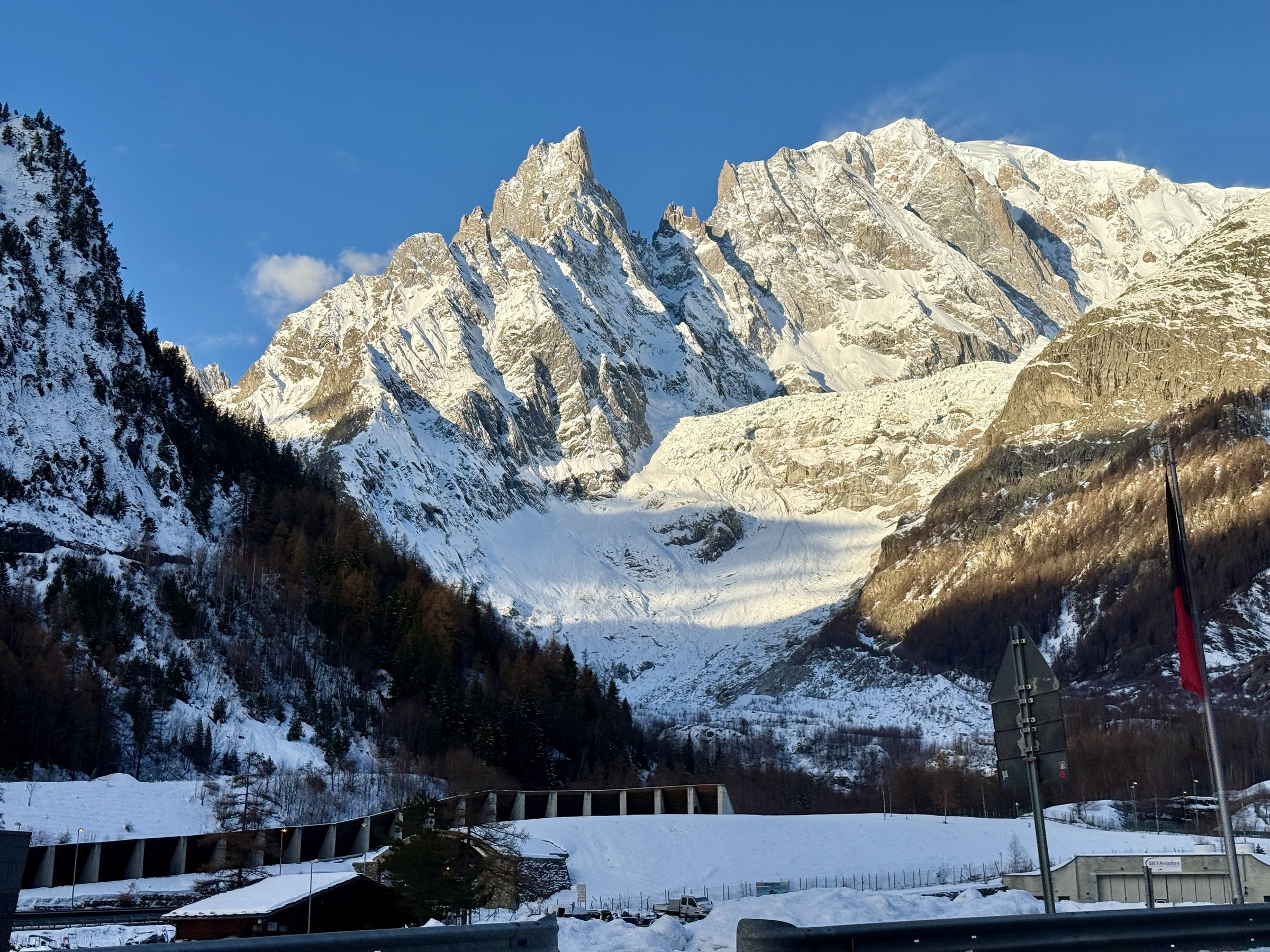 Snow-covered Mont Blanc massif in morning light above the valley near Courmayeur, Italian Alps