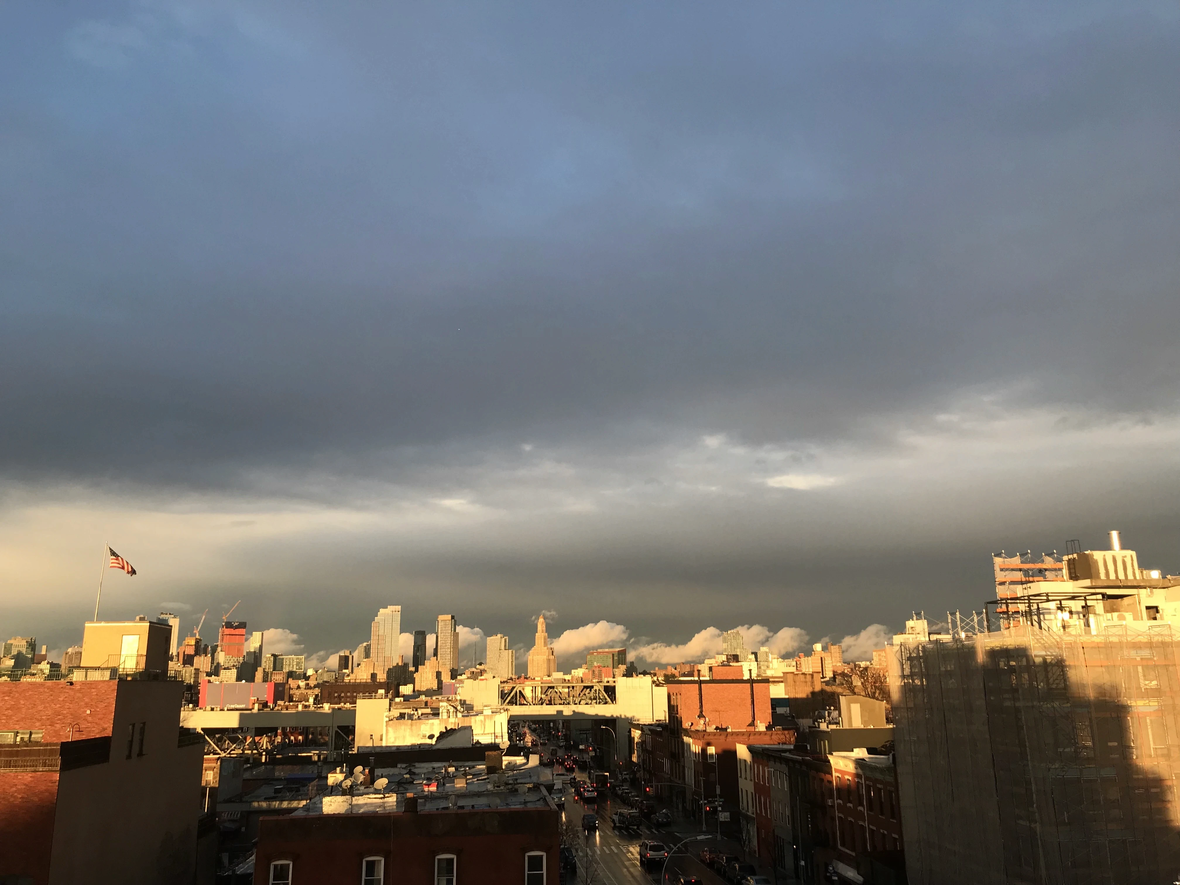 Grief therapy in NYC - Brooklyn rooftops under a clearing sky