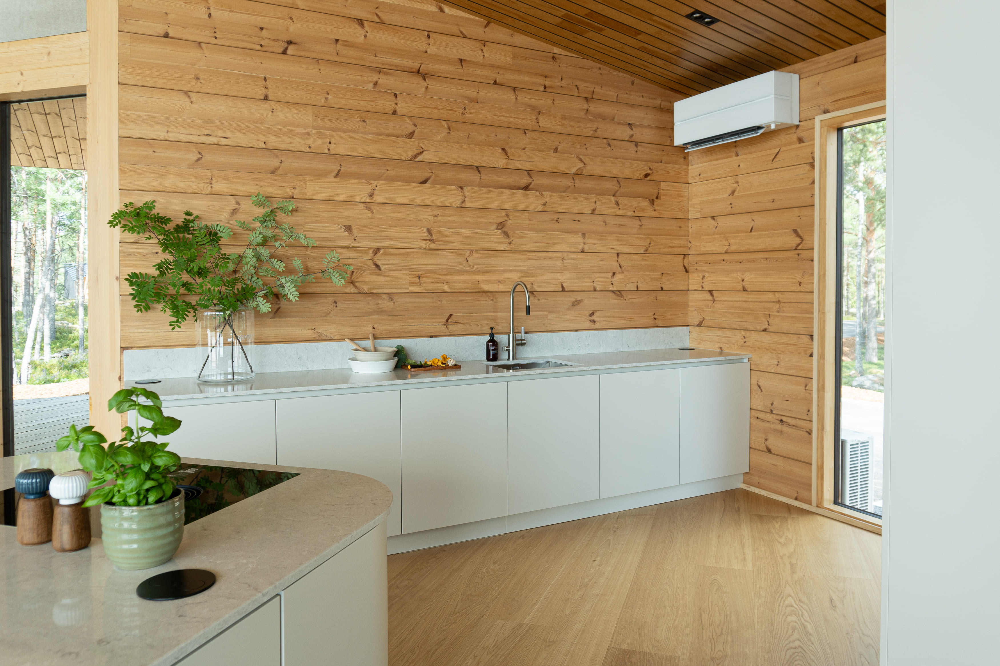 Kitchen with wooden walls and white desk