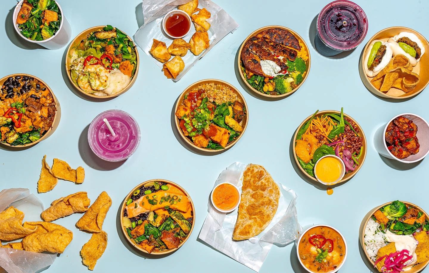 A colorful array of FIELDTRIP’s signature dishes, including jollof rice bowls, shrimp curry, crispy crab pockets, and sweet plantains with hot honey. A feast of global flavors inspired by the African diaspora.