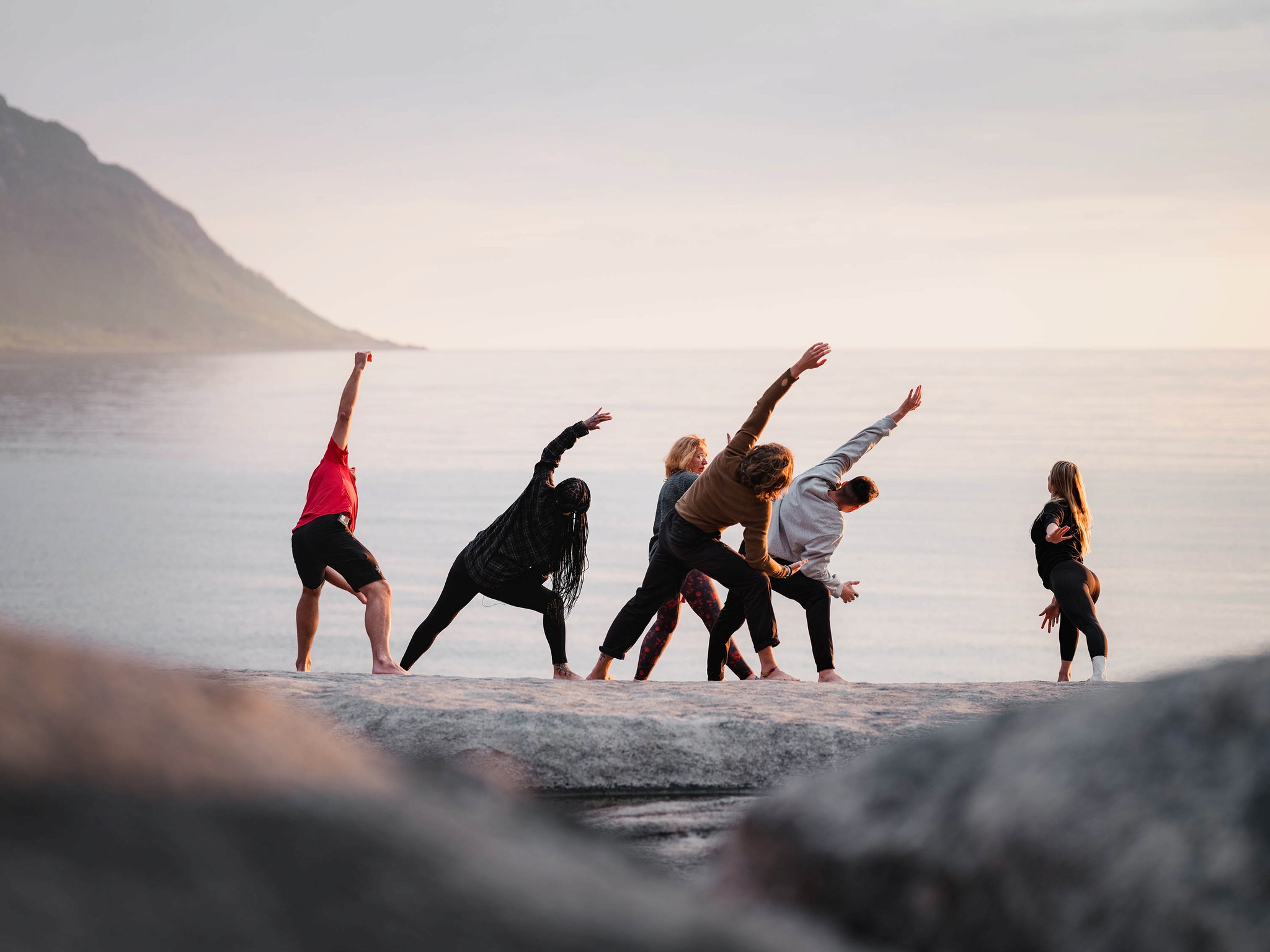Person, holding a white rose behind his back with one arm on a light blue background