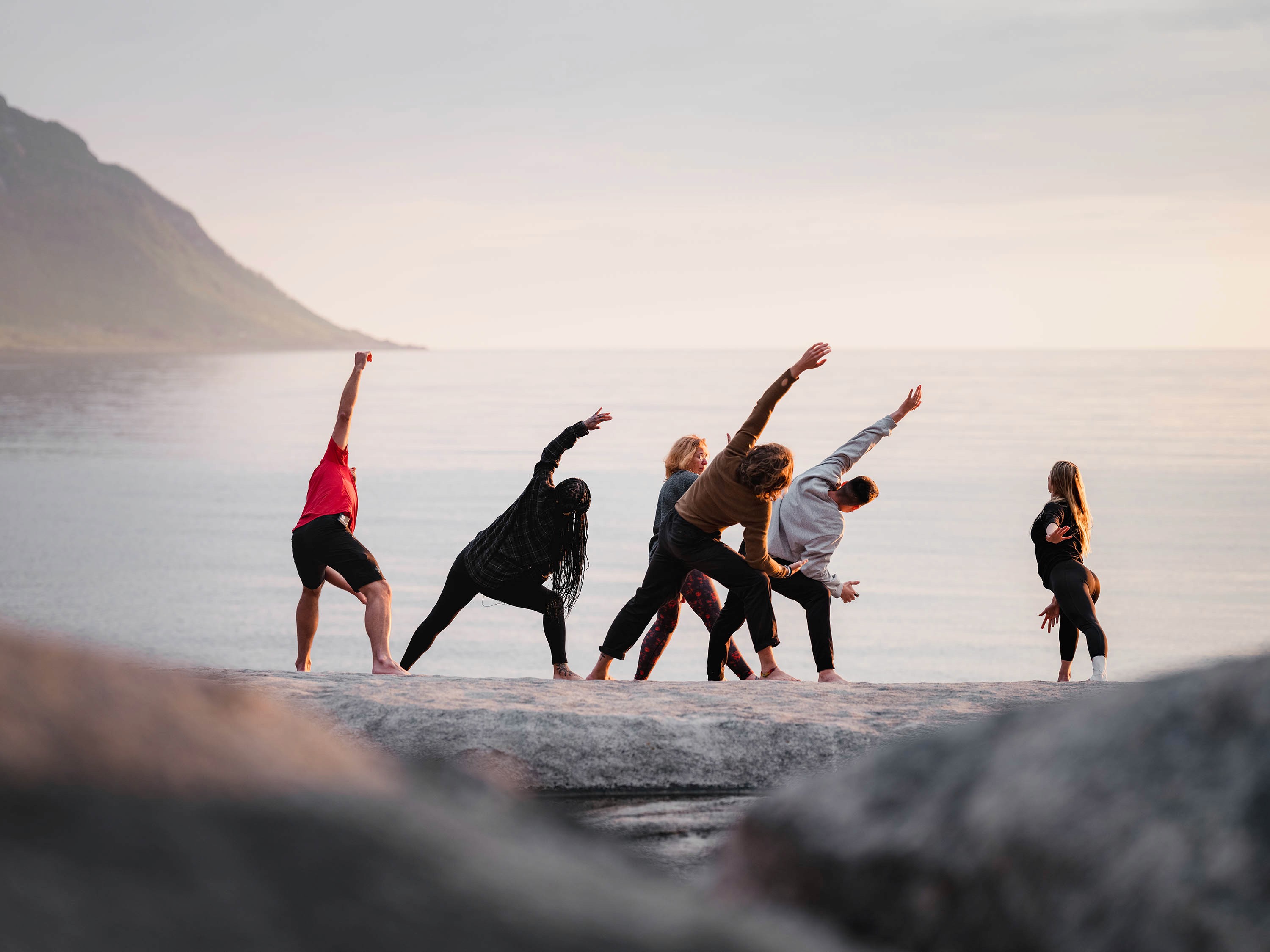 Person, holding a white rose behind his back with one arm on a light blue background