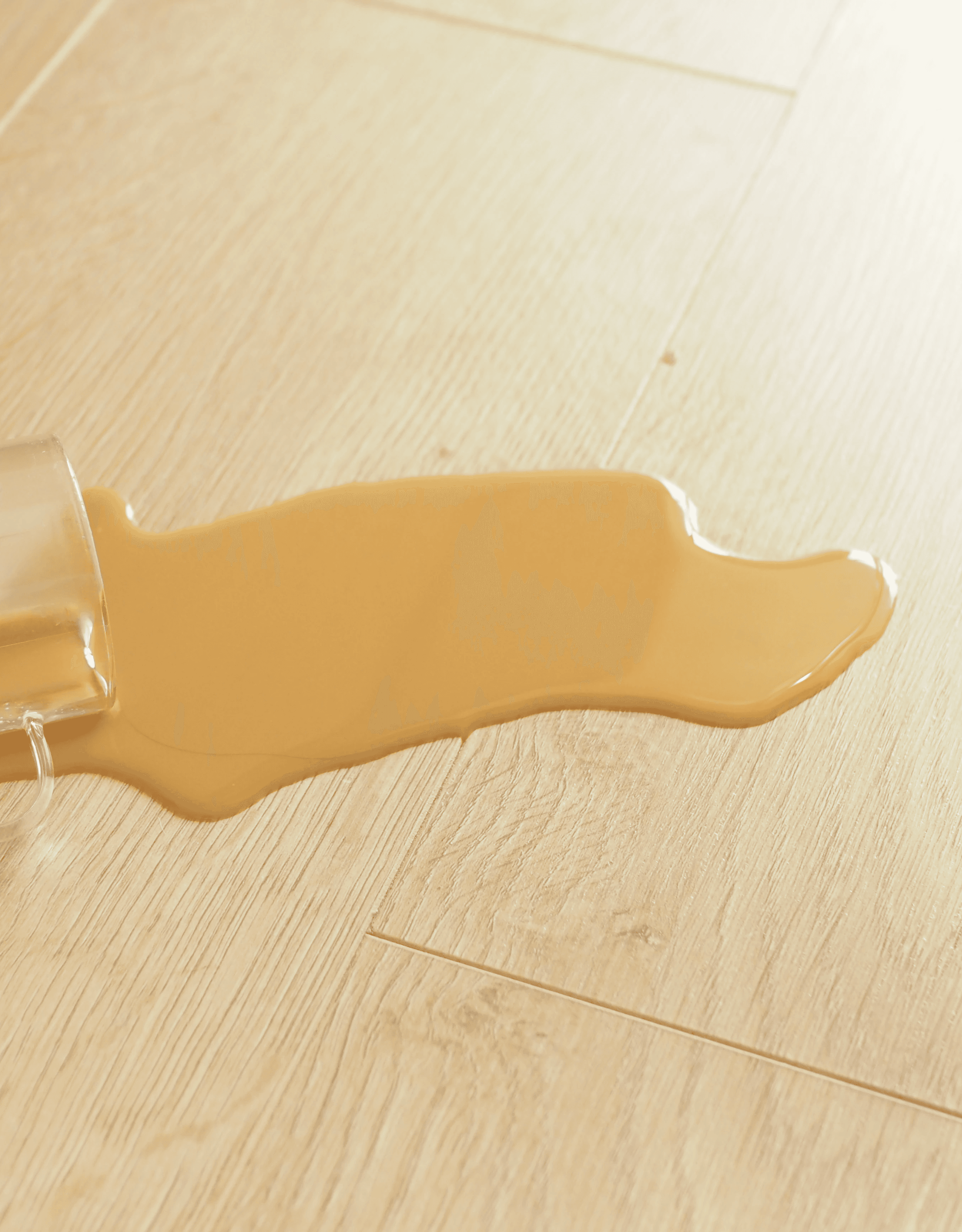 Coffee spills on a Brisbane home floor, wiped clean thanks to water- and stain-resistant hybrid flooring that handles everyday accidents without stress.