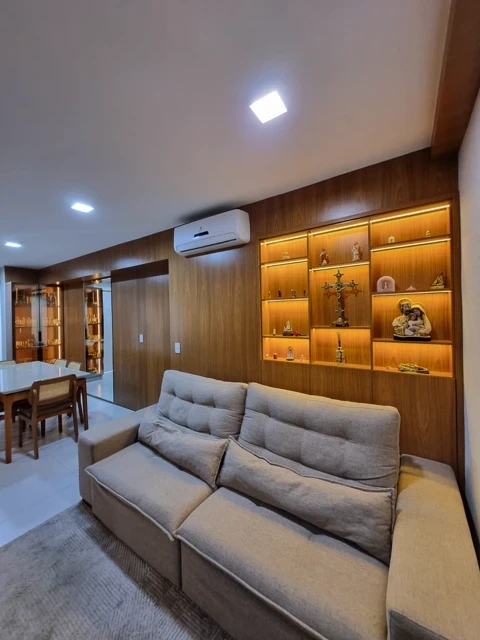 A spacious, modern living room showcases minimalist interior design with high ceilings, and a wooden accent wall.