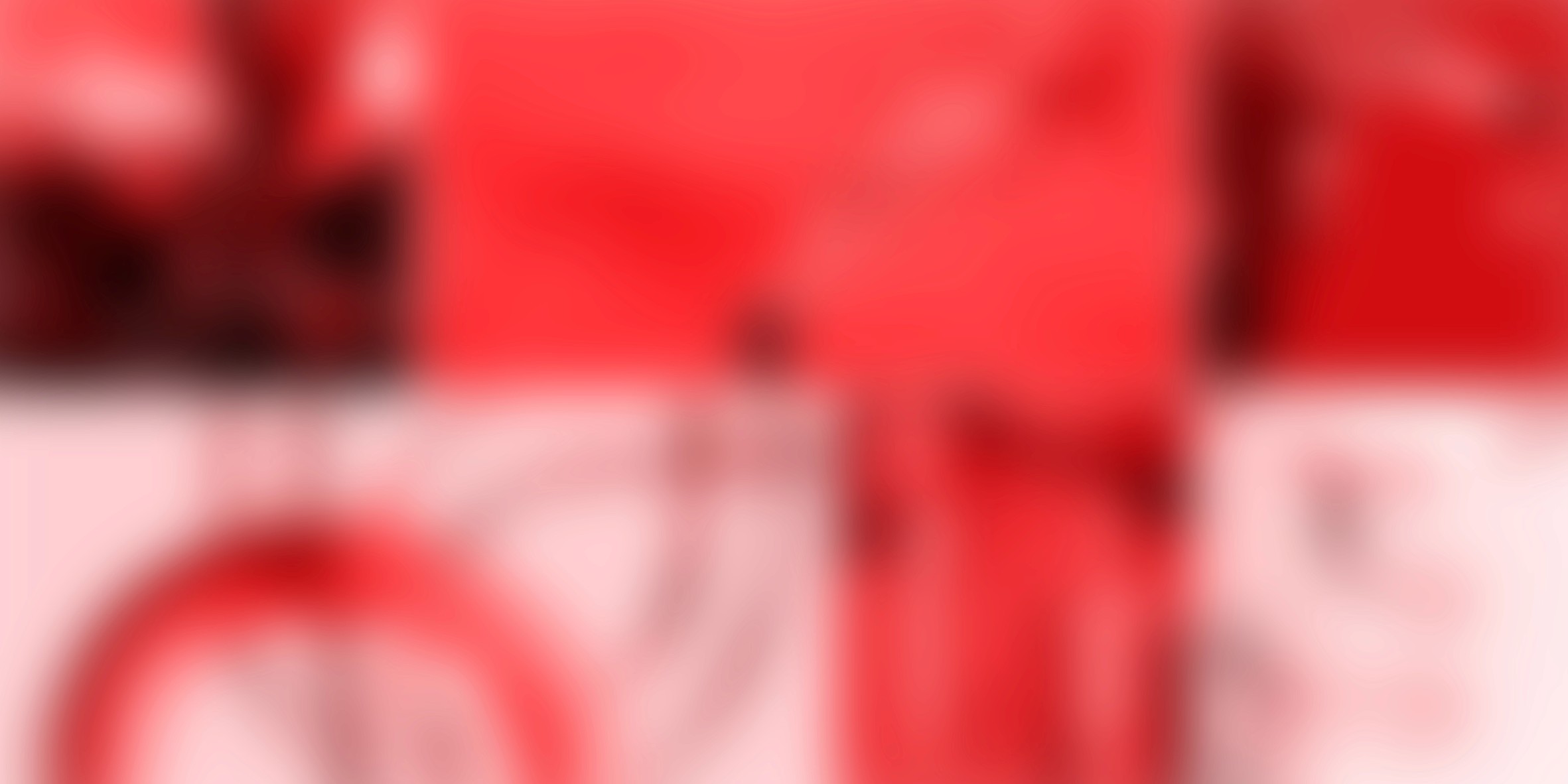 Slightly blurred image of a smart speaker with a glowing top, on a circular base.