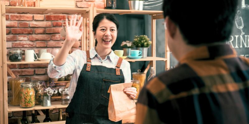 A Malaysian F&B staff serving a customer