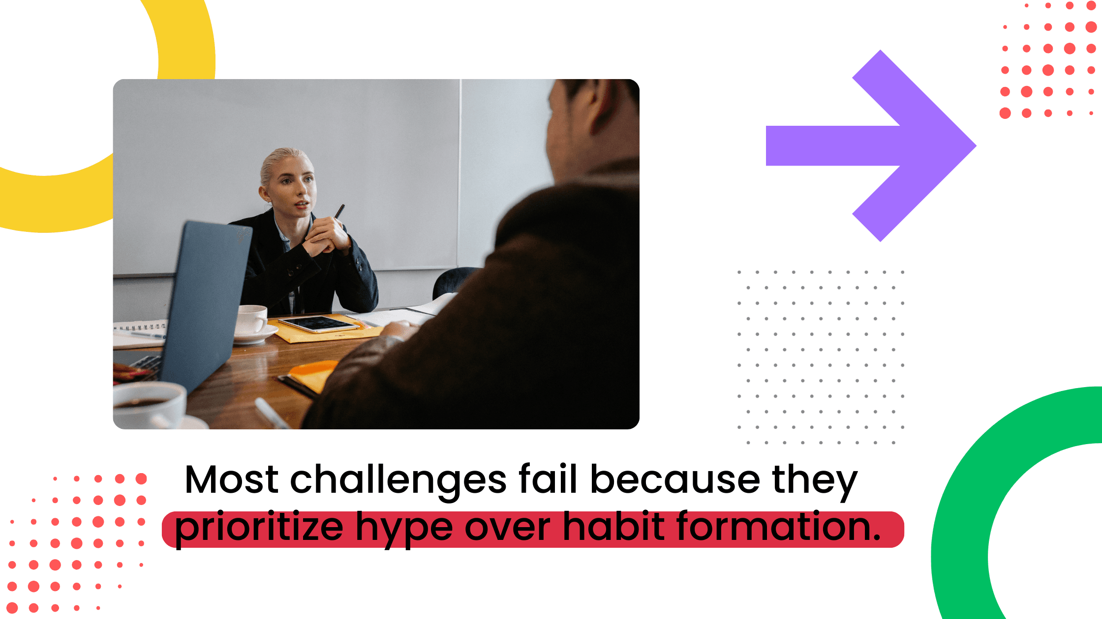 Professional woman speaking across a desk to a seated participant in a coaching session.