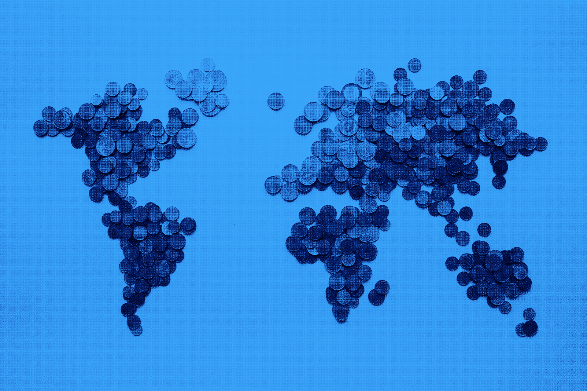 Close-up of a scientist holding a tray of petri dishes with purple cultures, wearing gloves and safety gear.
