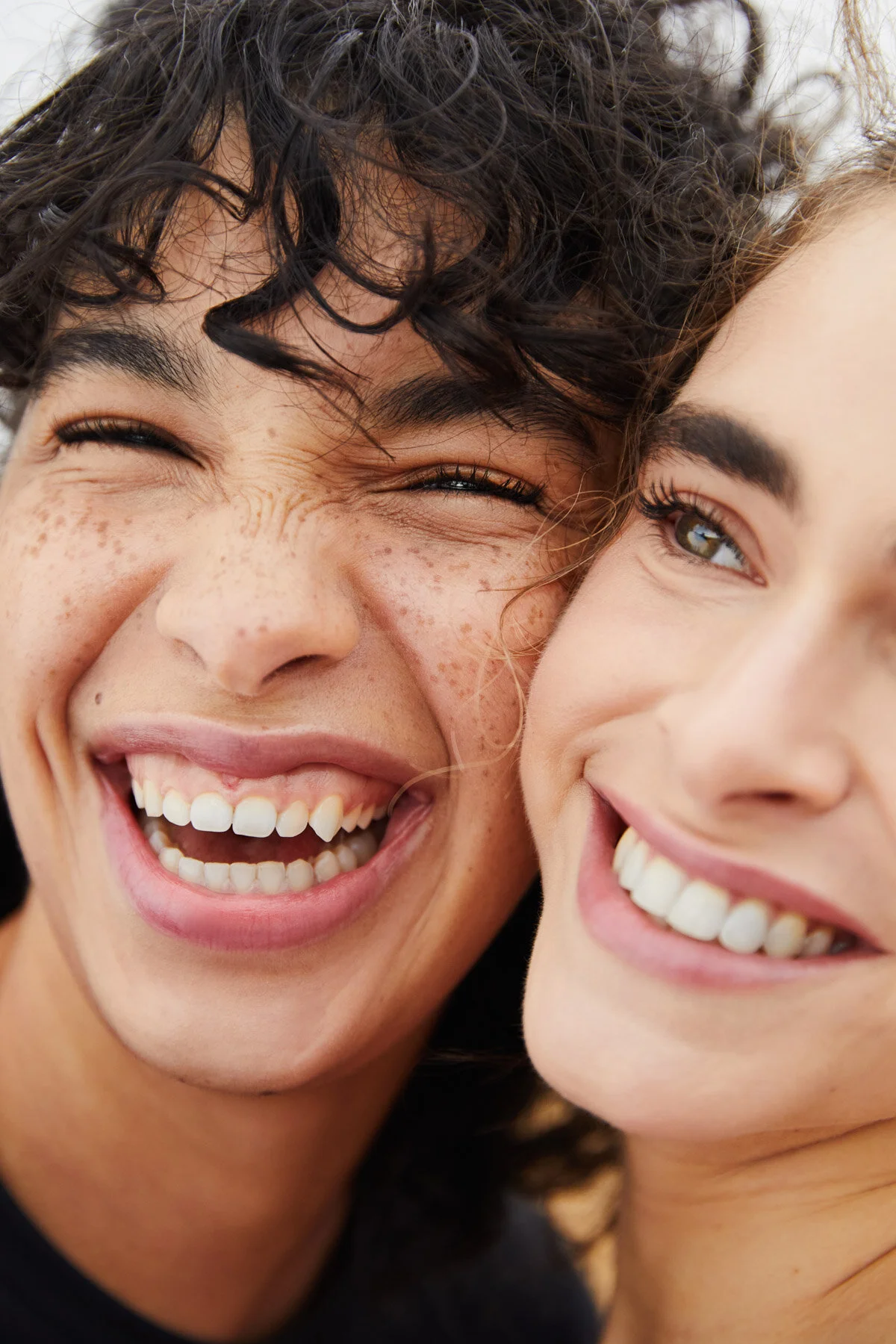 a guy and a lady, faces together and smiling