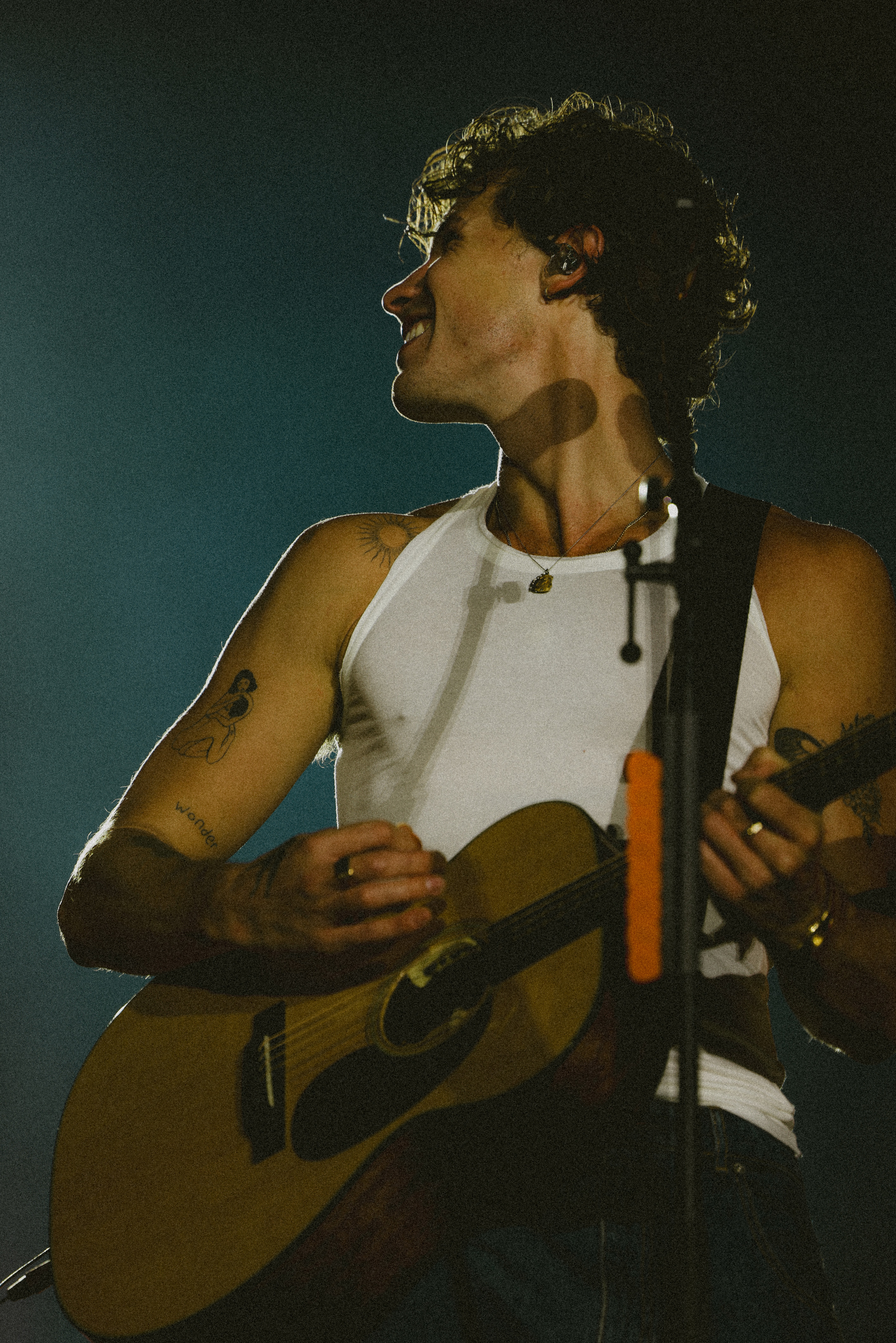 Stylish individual with platinum blonde hair, sunglasses, and leather outfit