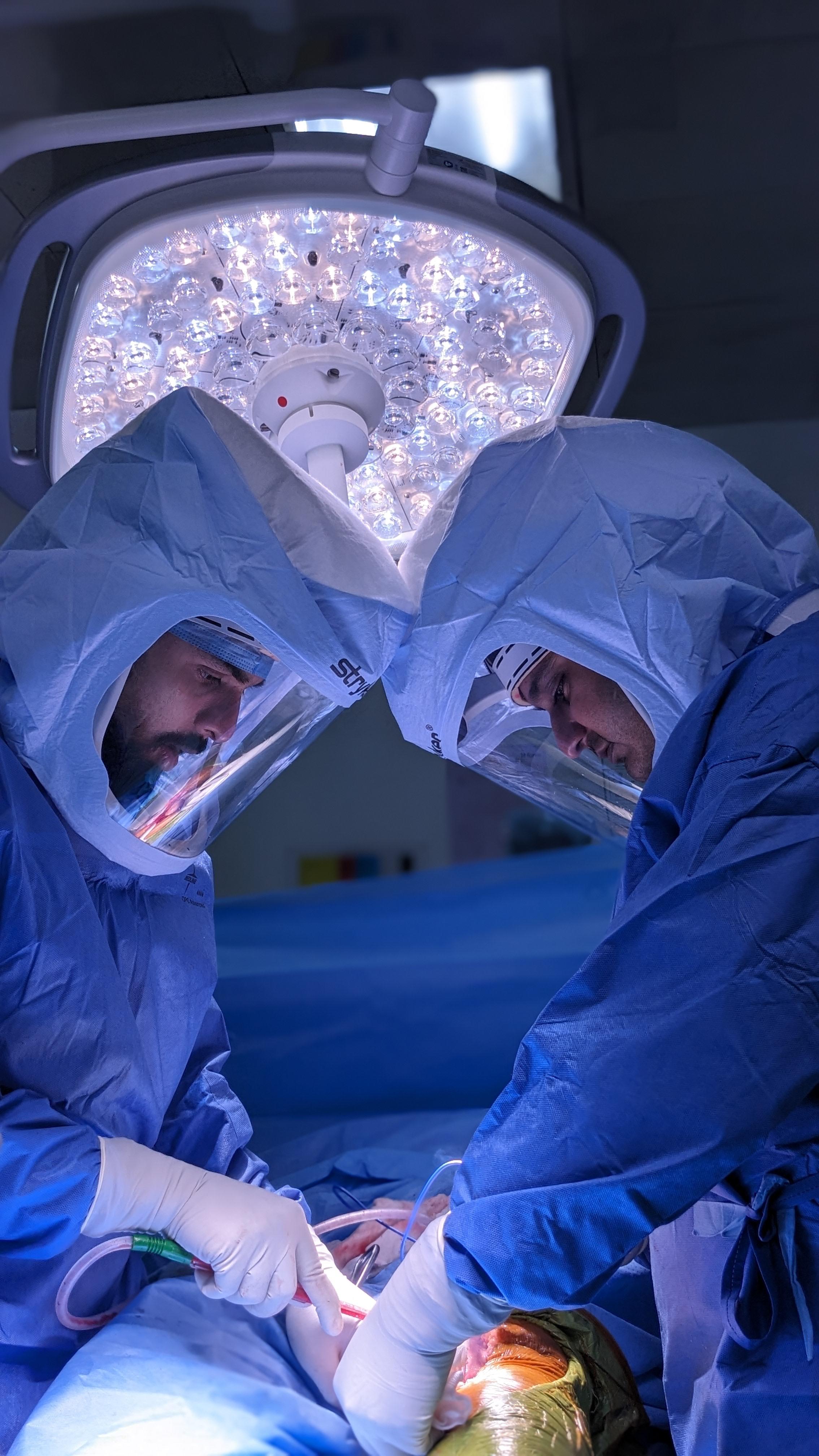 a group of doctors performing surgery on a patient