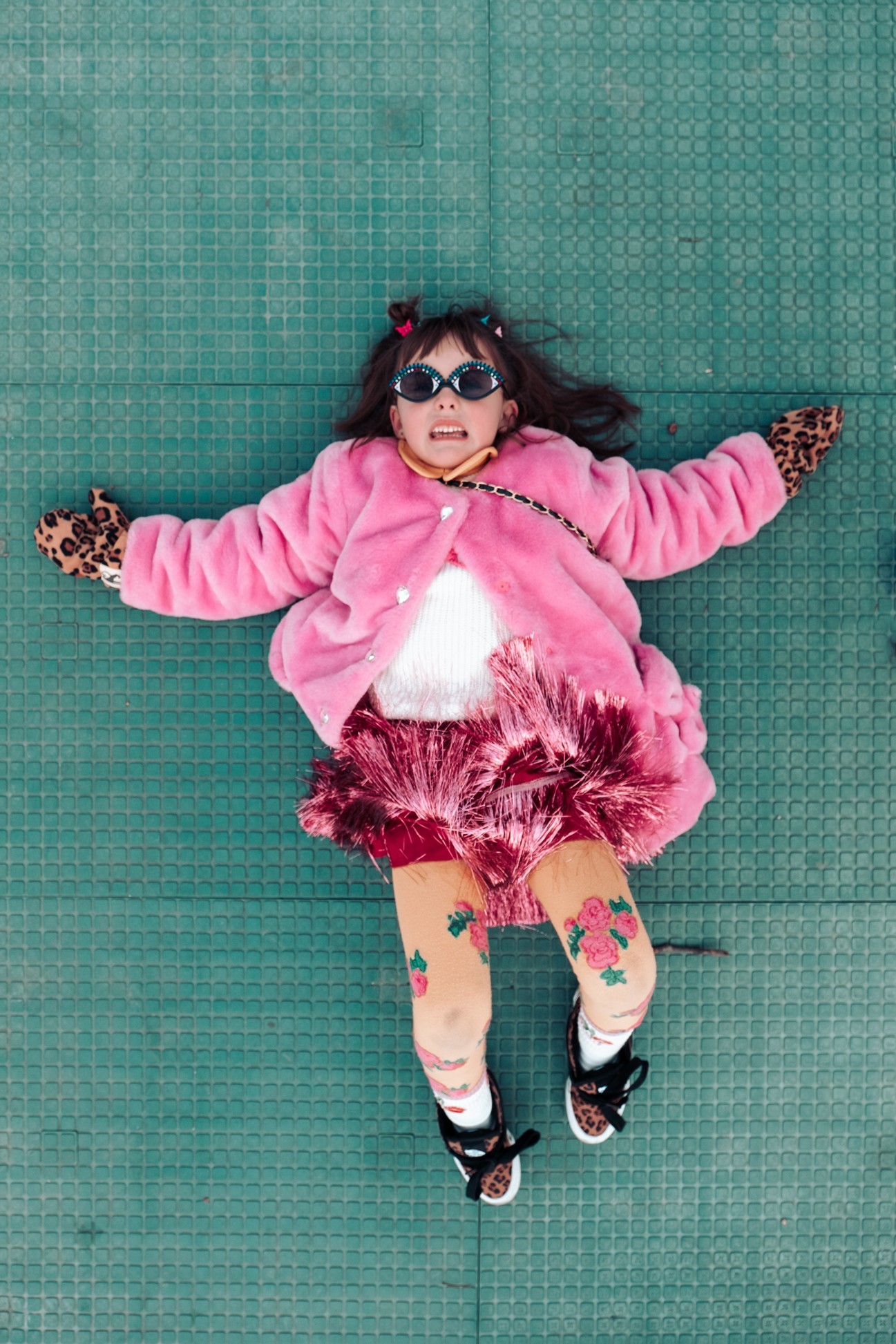 katt-jones-overhead-view-child-laying-on-green-ground-nyc-photographer