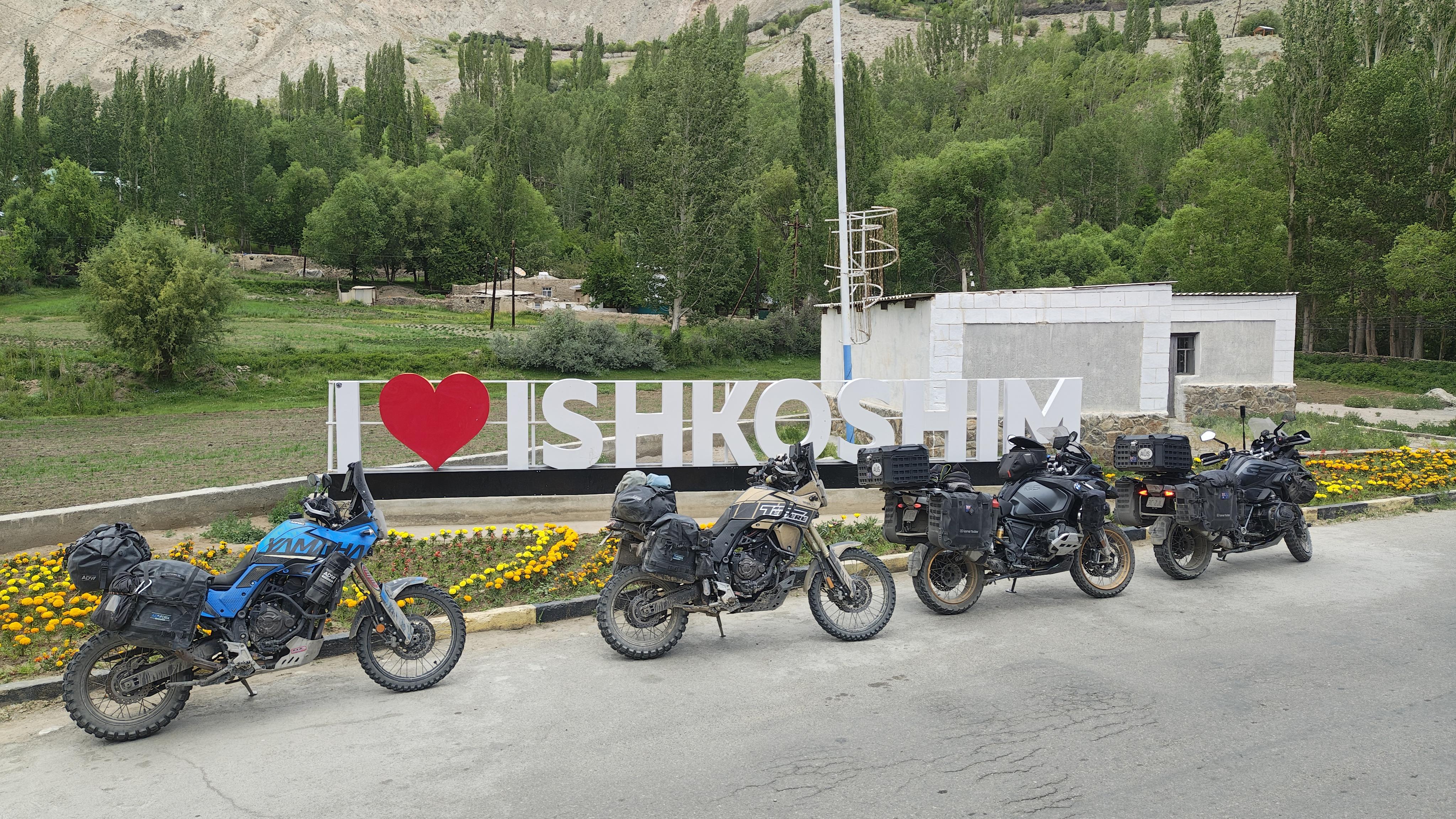 Four loaded touring motorcycles in Ishkashim on the Pamir Highway.