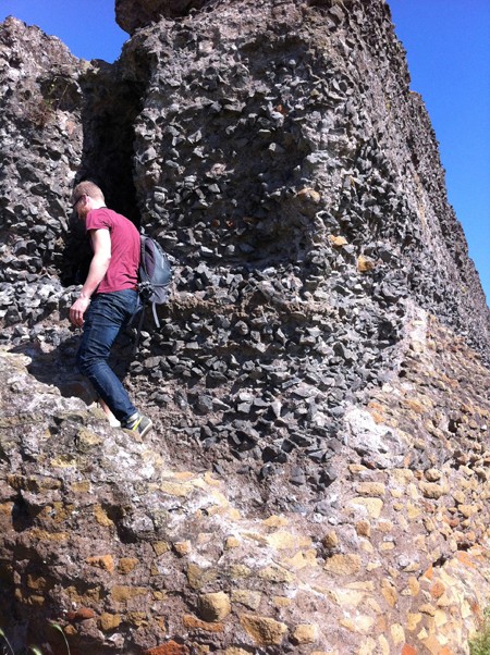 A man walking up the stone hill