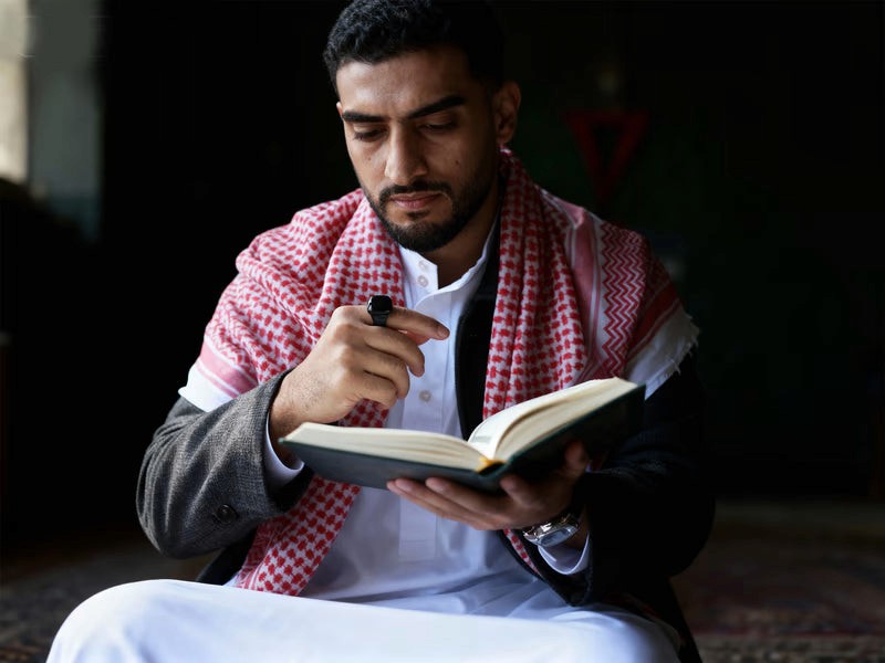 Muslim performing Salah with tasbih in peaceful home setting