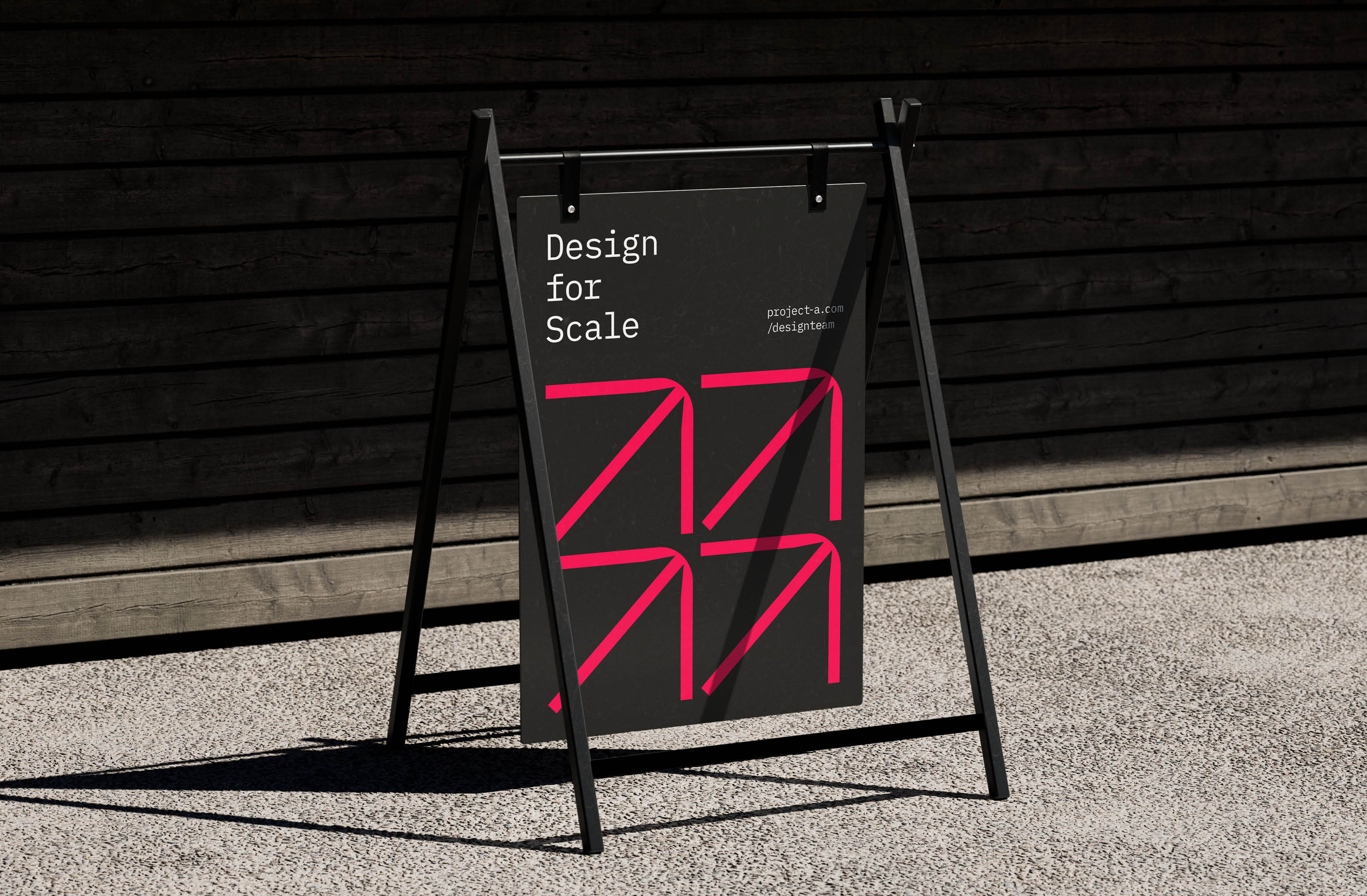Modern A-frame sign featuring bold pink graphics and the text 'Design for Scale', highlighting innovative design concepts.