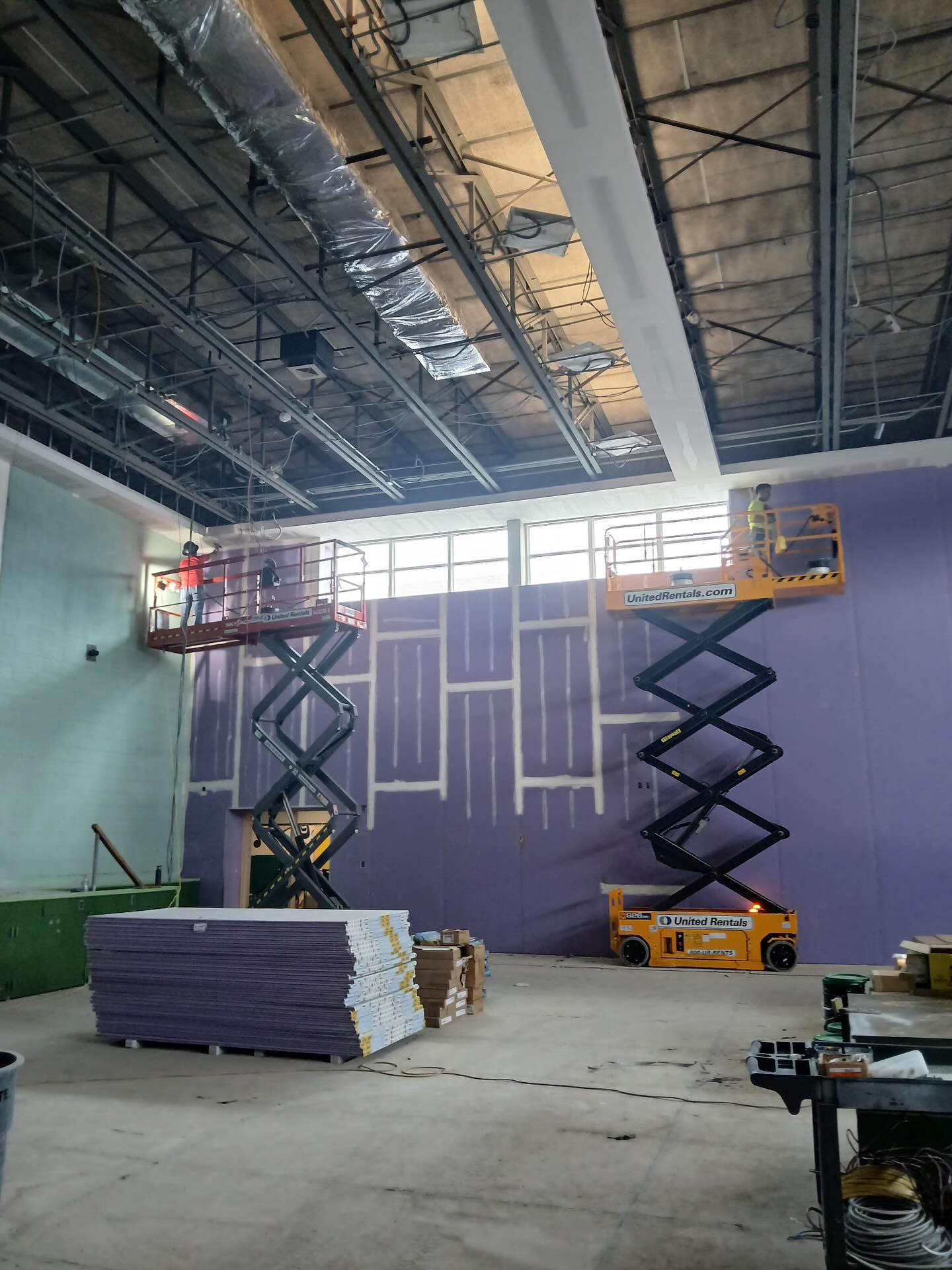Scissor lift work on tall commercial walls