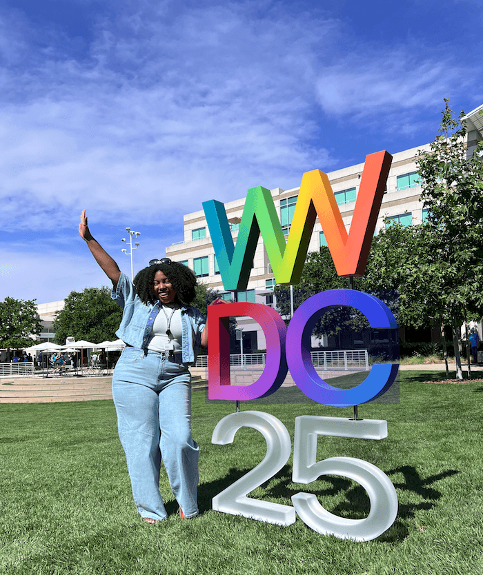 A close-up of a person wearing green-tinted glasses, with a serious expression and smooth skin.