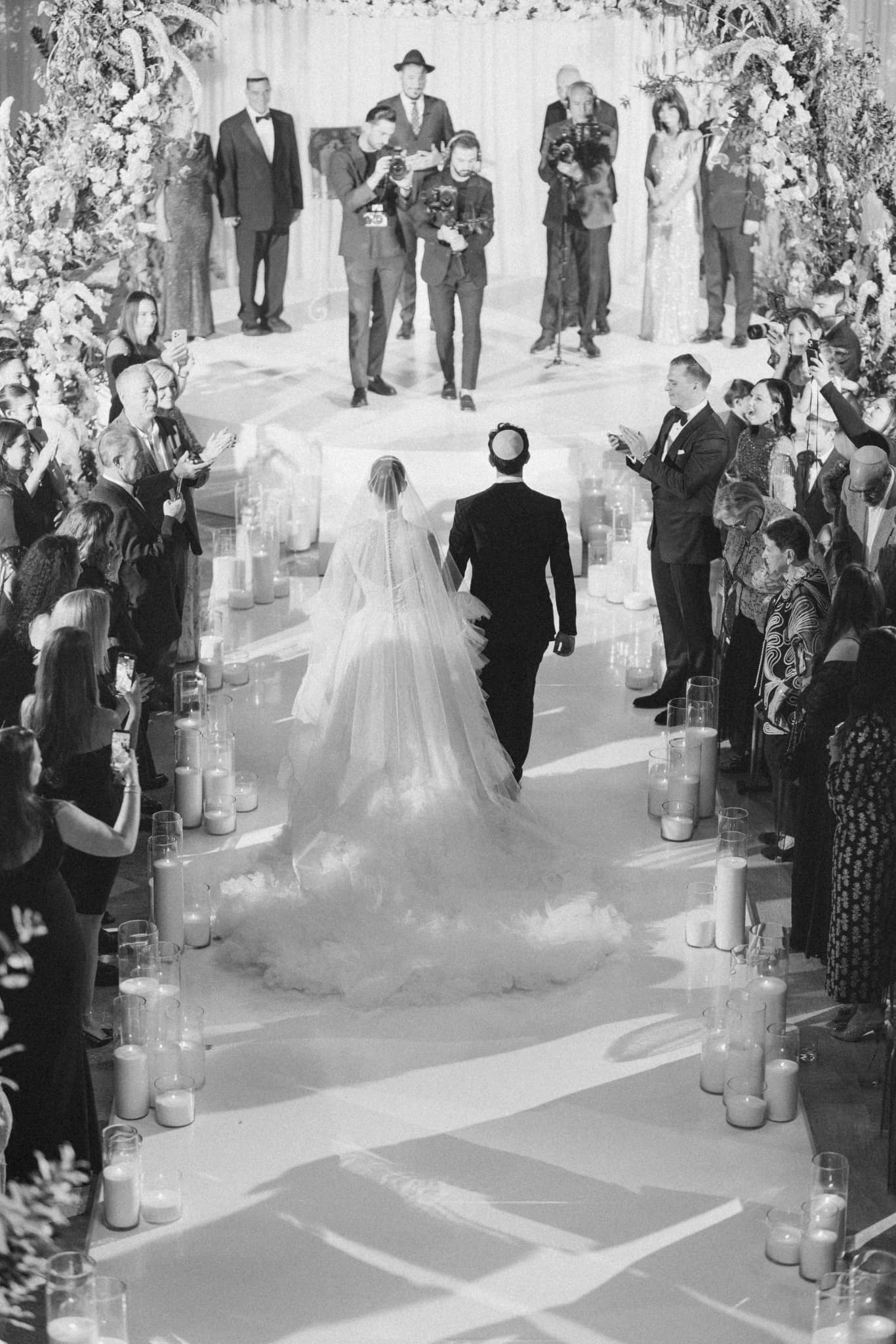 Tree branches reach towards a clear, blue sky.