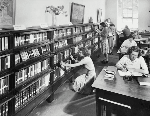 High school student conducting original history research with a PhD mentor at a university library