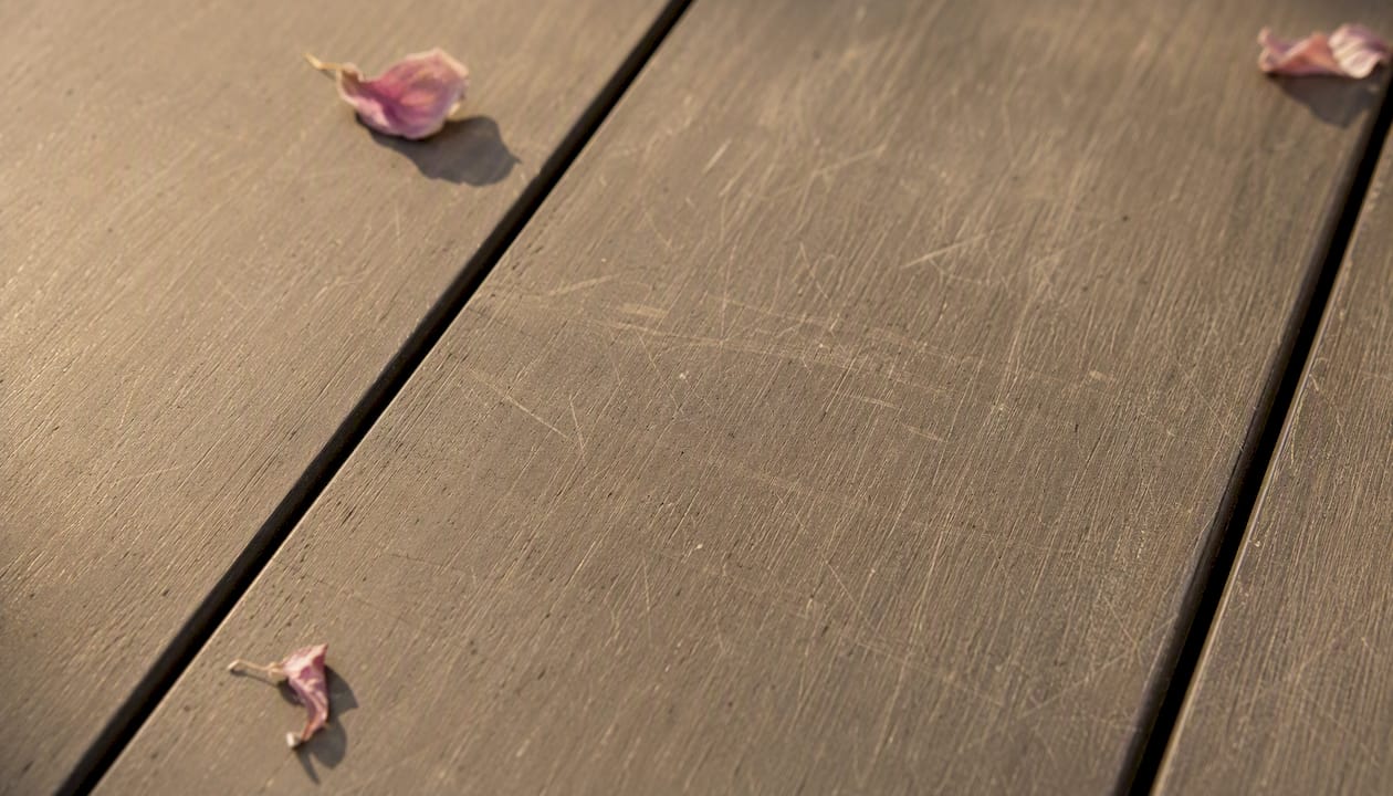 Close-up of composite decking surface scratches