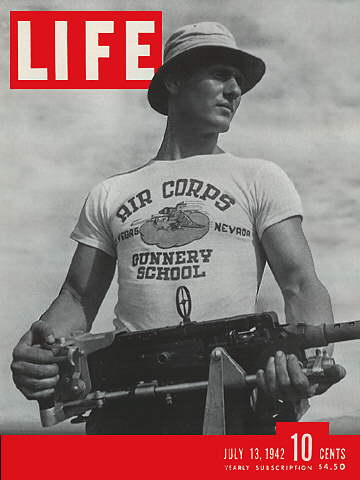 The cover of LIFE Magazine showing a soldier holding a gun wearing a graphic tee shirt that reads air corps gunnery school