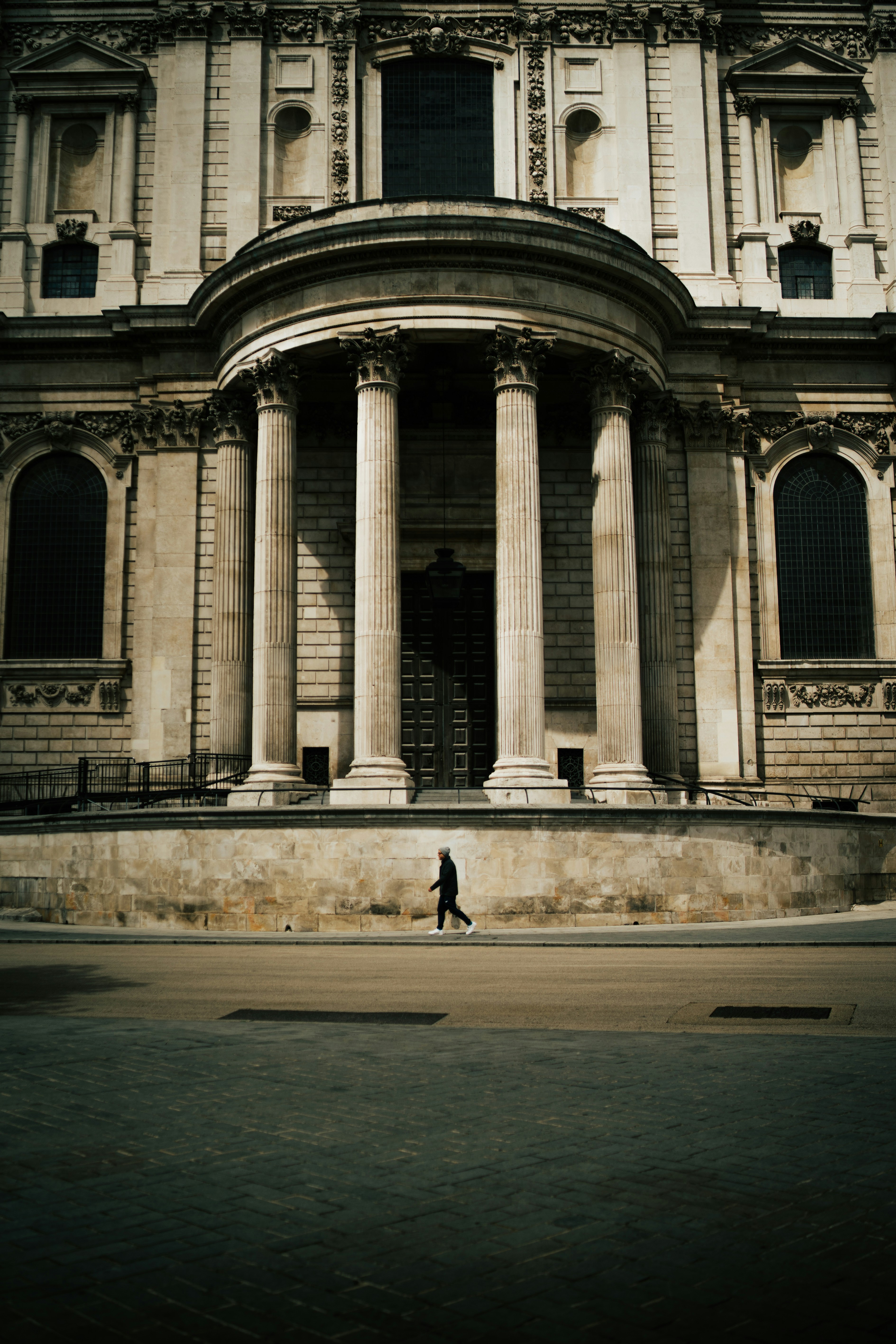 A person facing a monumental building