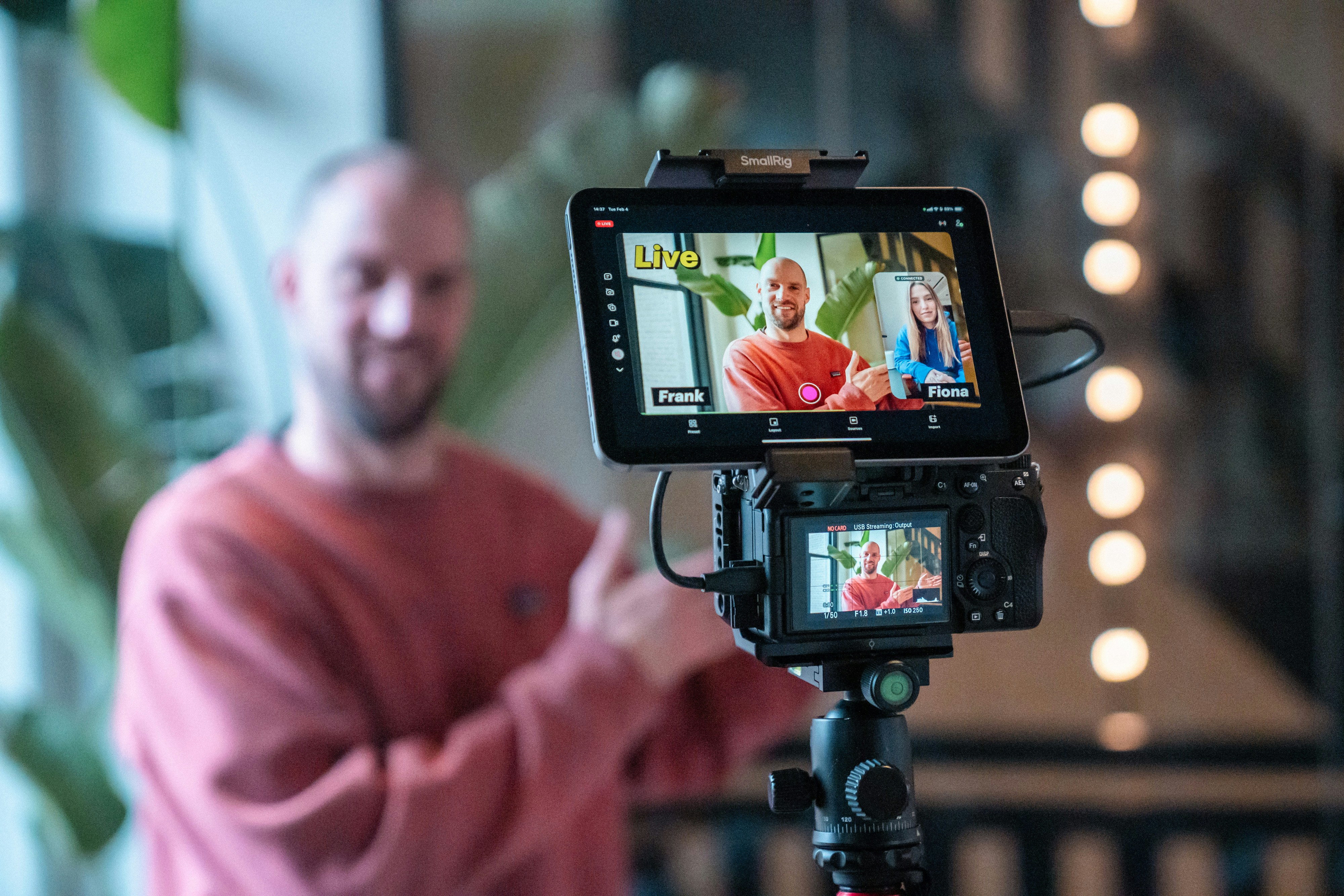 Man filming a video call on a camera.
