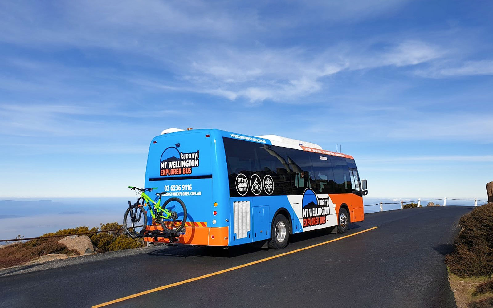 Kunanyi/Mt Wellington Explorer Bus on mountain road with bike rack.