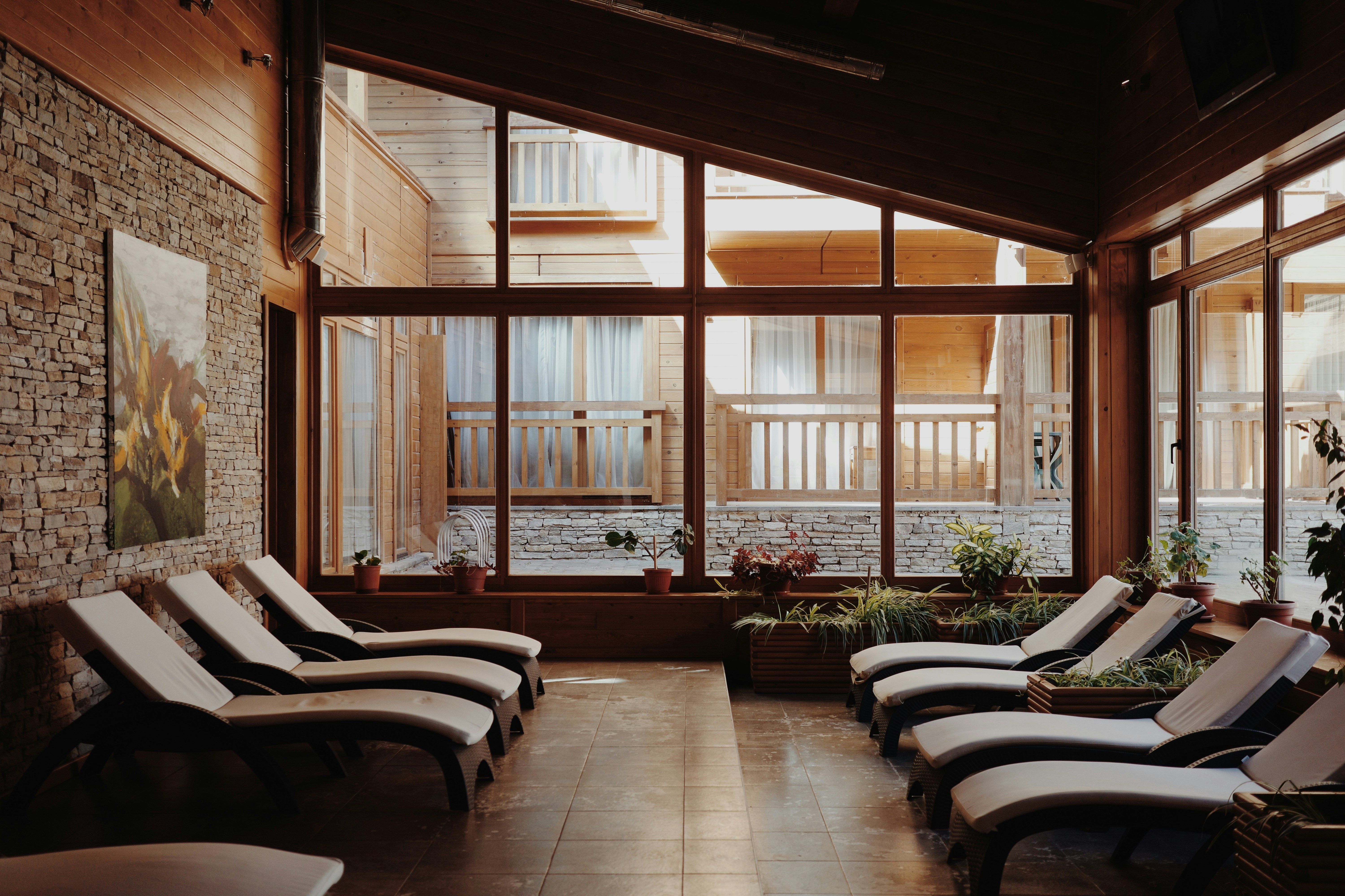 Relaxing lounge chairs in a sunlit spa room.