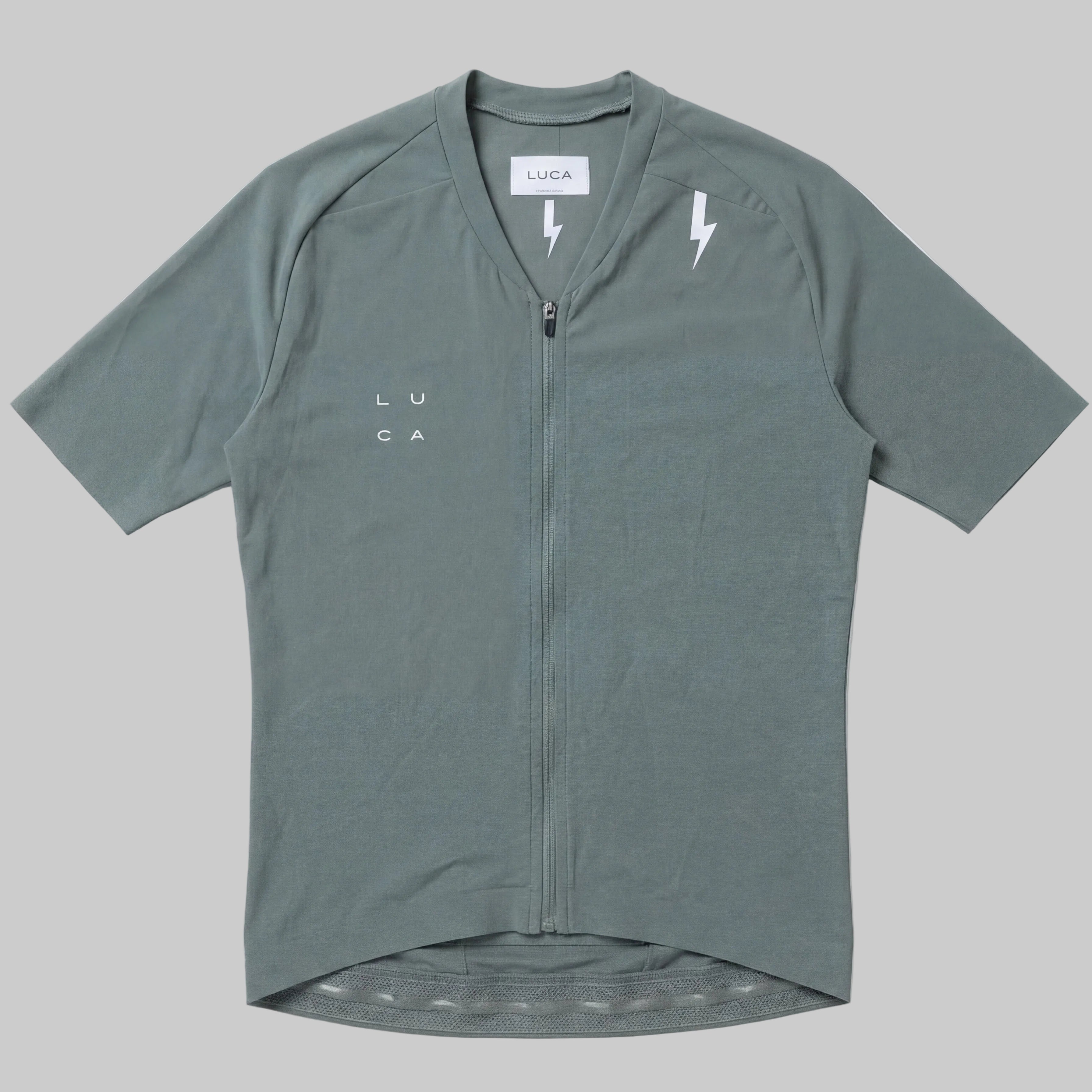 LUCA Soleil women's cycling jersey in matcha - front flat lay with V-neckline and bolt detail
