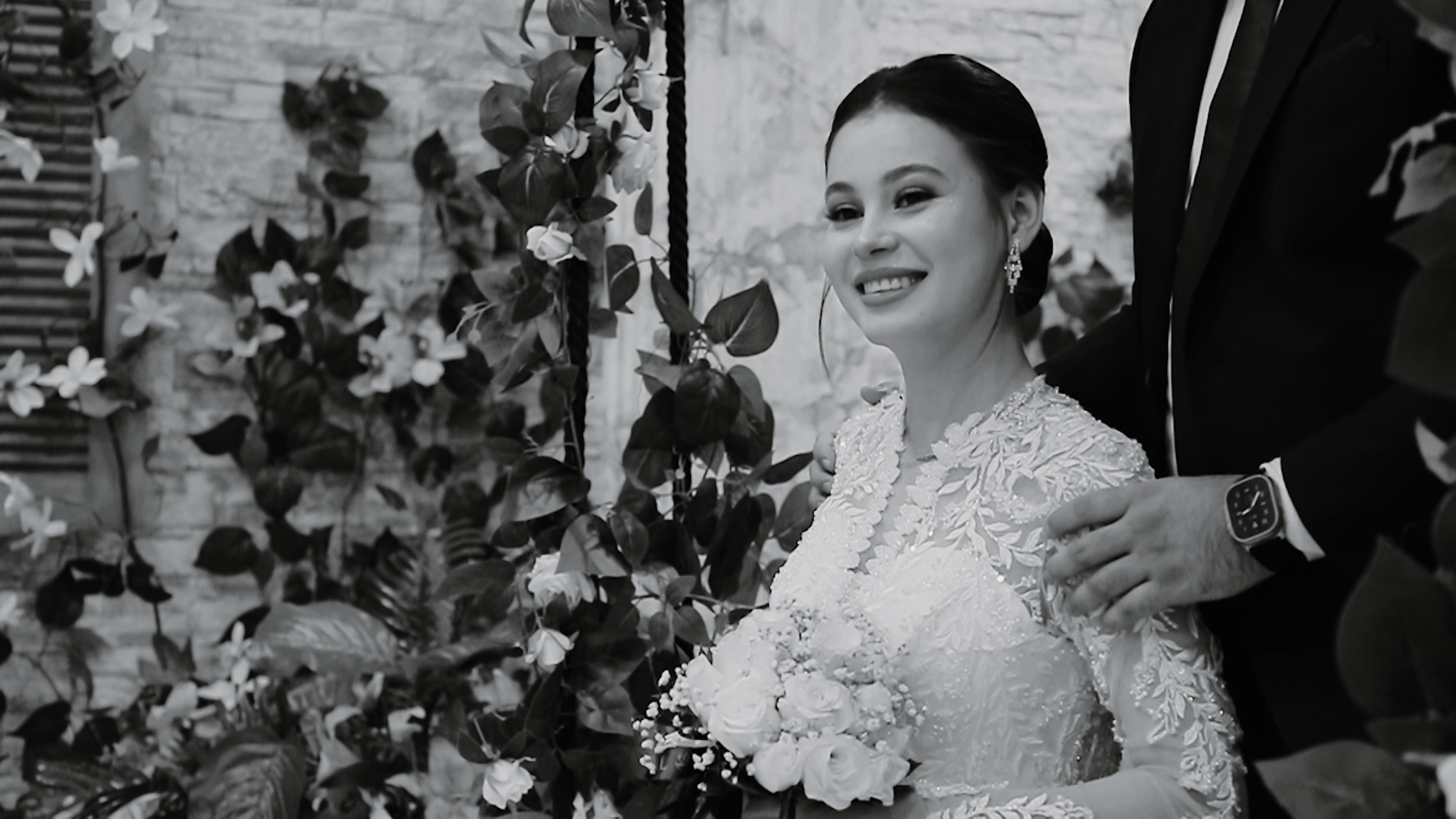Bride holding a bouquet during a destination wedding ceremony, captured in a timeless black and white moment