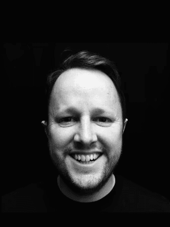 A professional headshot of a man