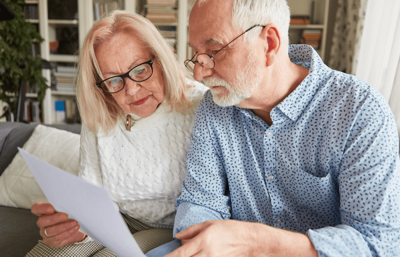 Senior couple reading a retirement plan or power of attorney or living will