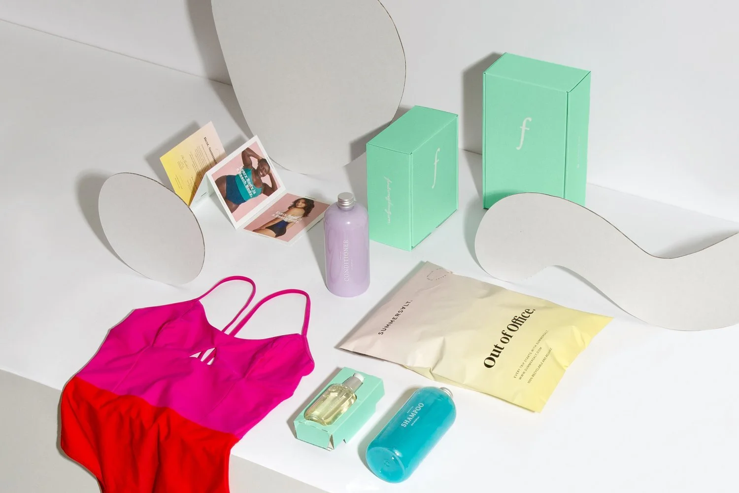 Apparel and beauty products laid out with mailers and cartons