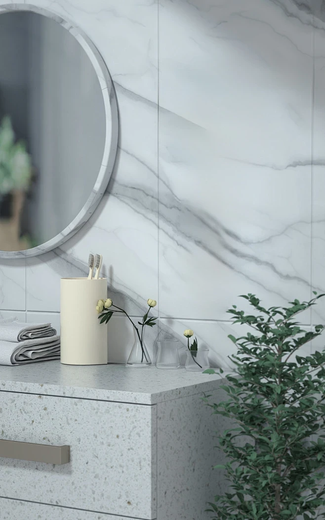 A modern bathroom vanity area with white marble wall tiles, decorated with a mirror and small plants.